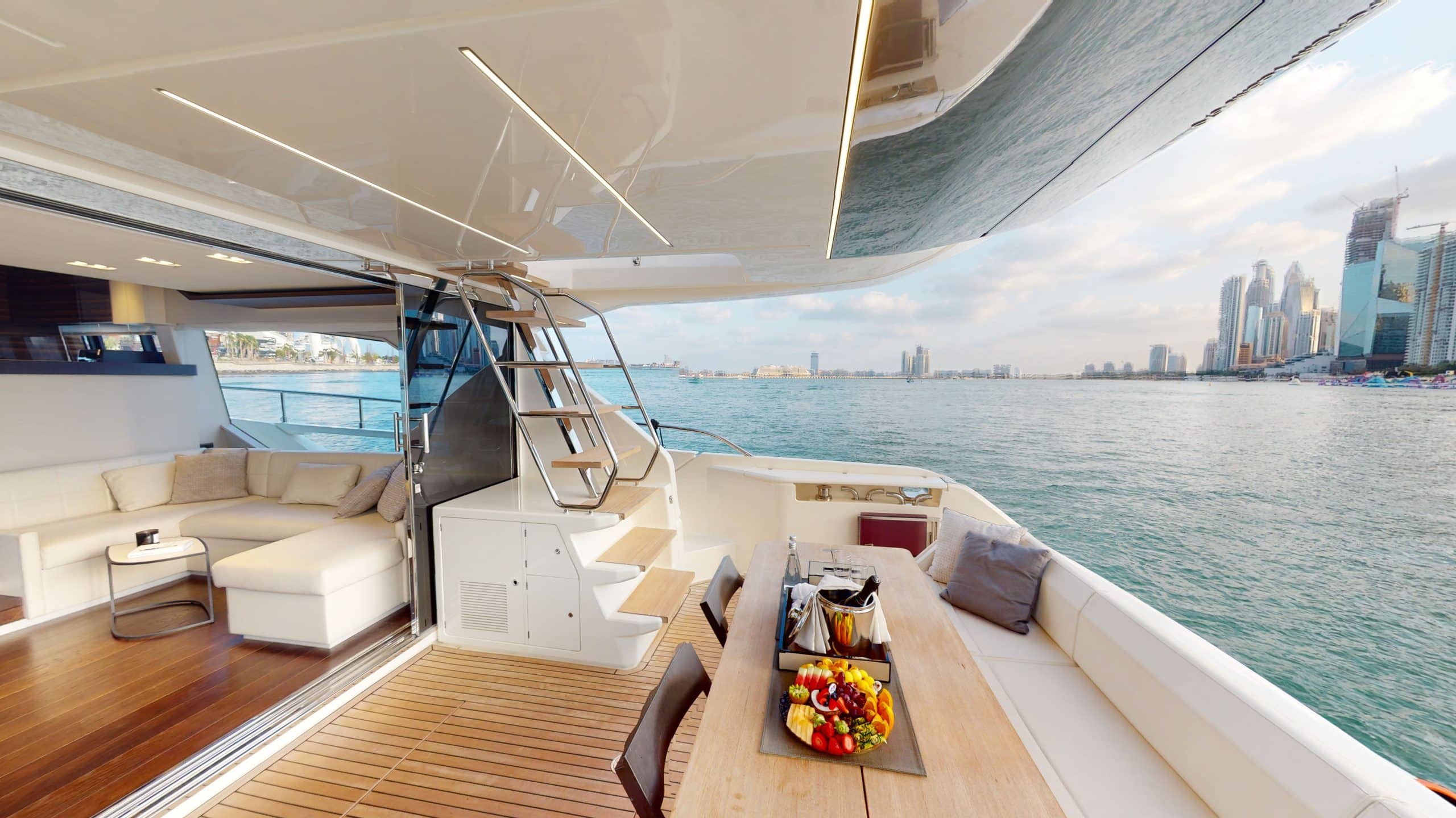 Aft deck seating area with sun lounge on Ferretti 670 yacht