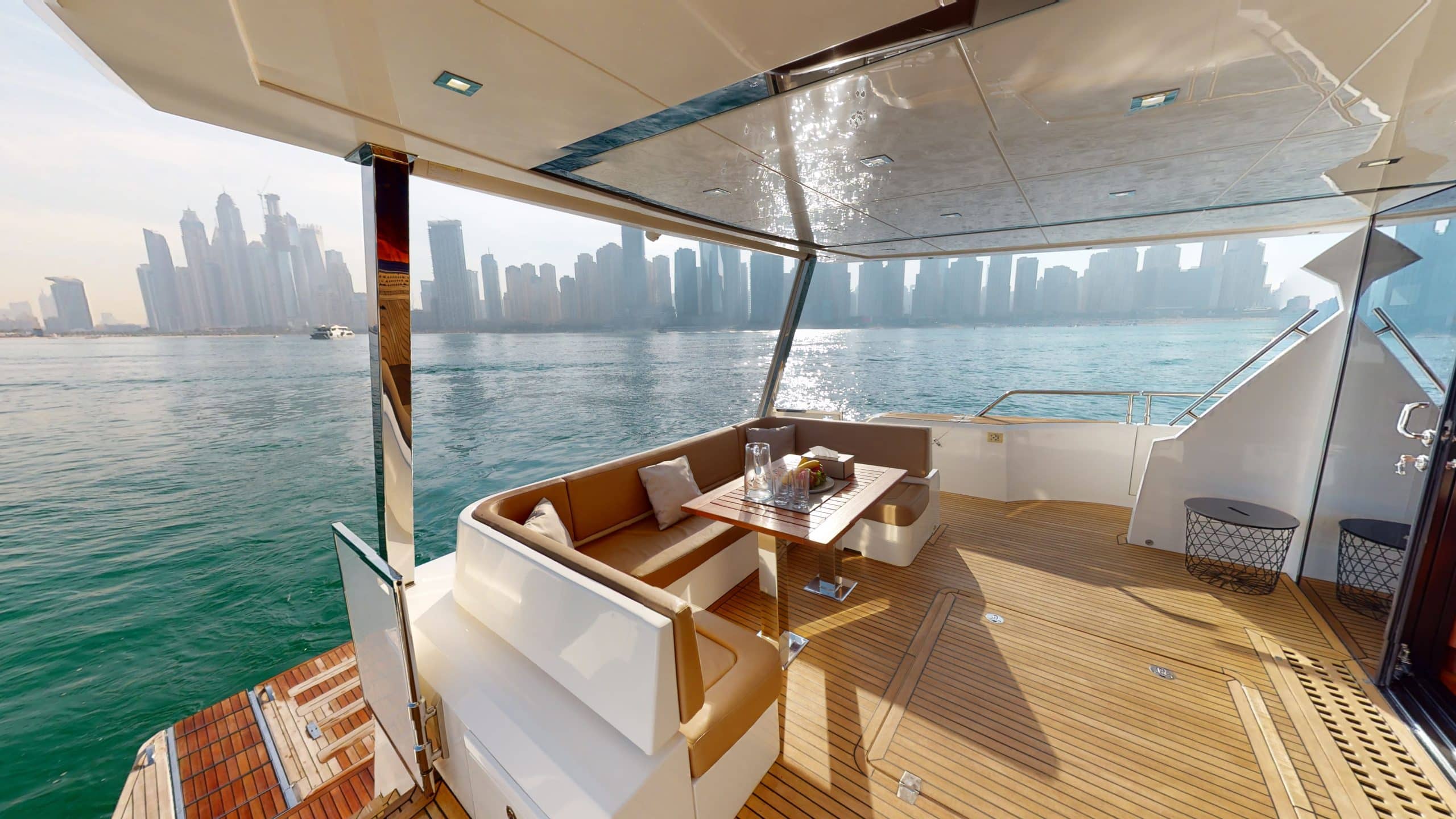 Galeon 780 F1 yacht outdoor dining area with sea view and luxury seating