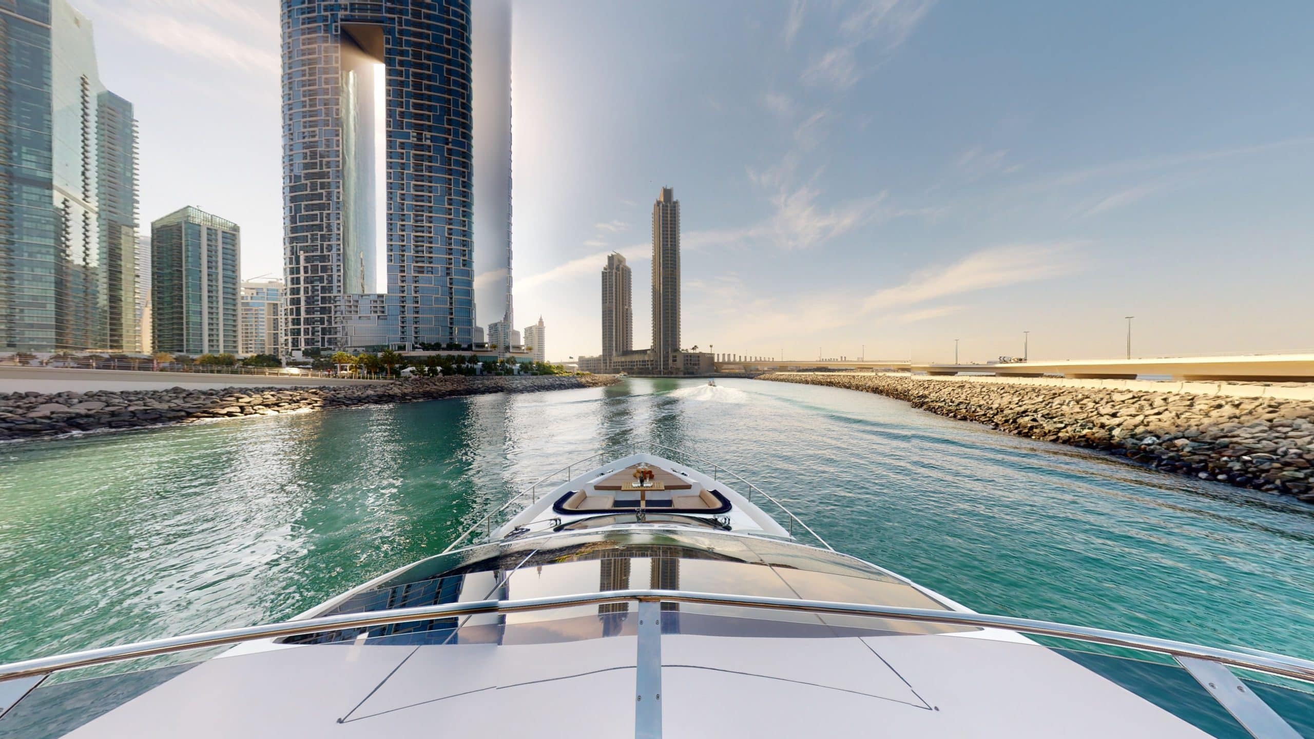 Galeon 780 F1 luxury yacht bow cruising view with city skyline and open water