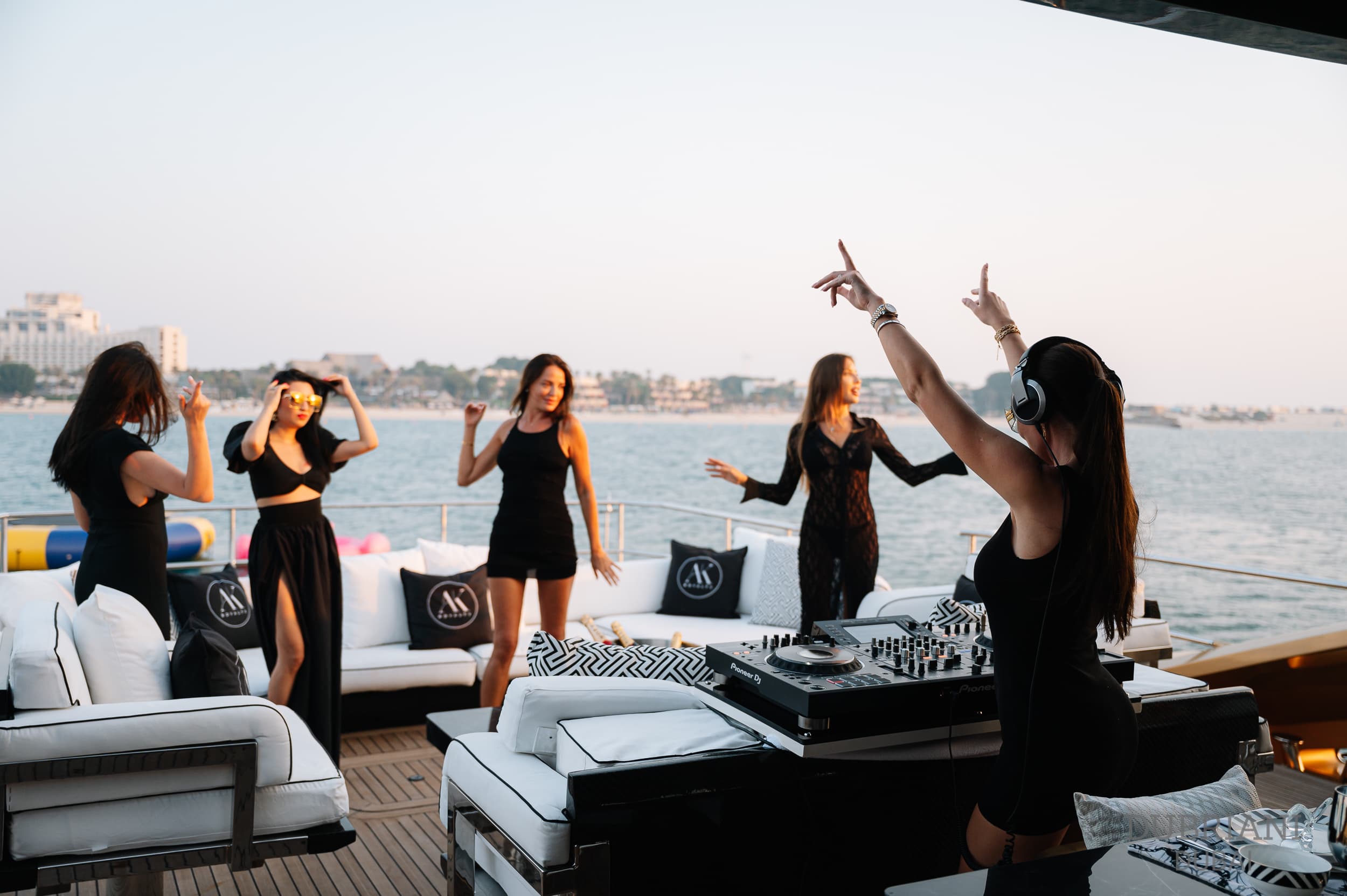 Group of women enjoying a yacht party at sunset