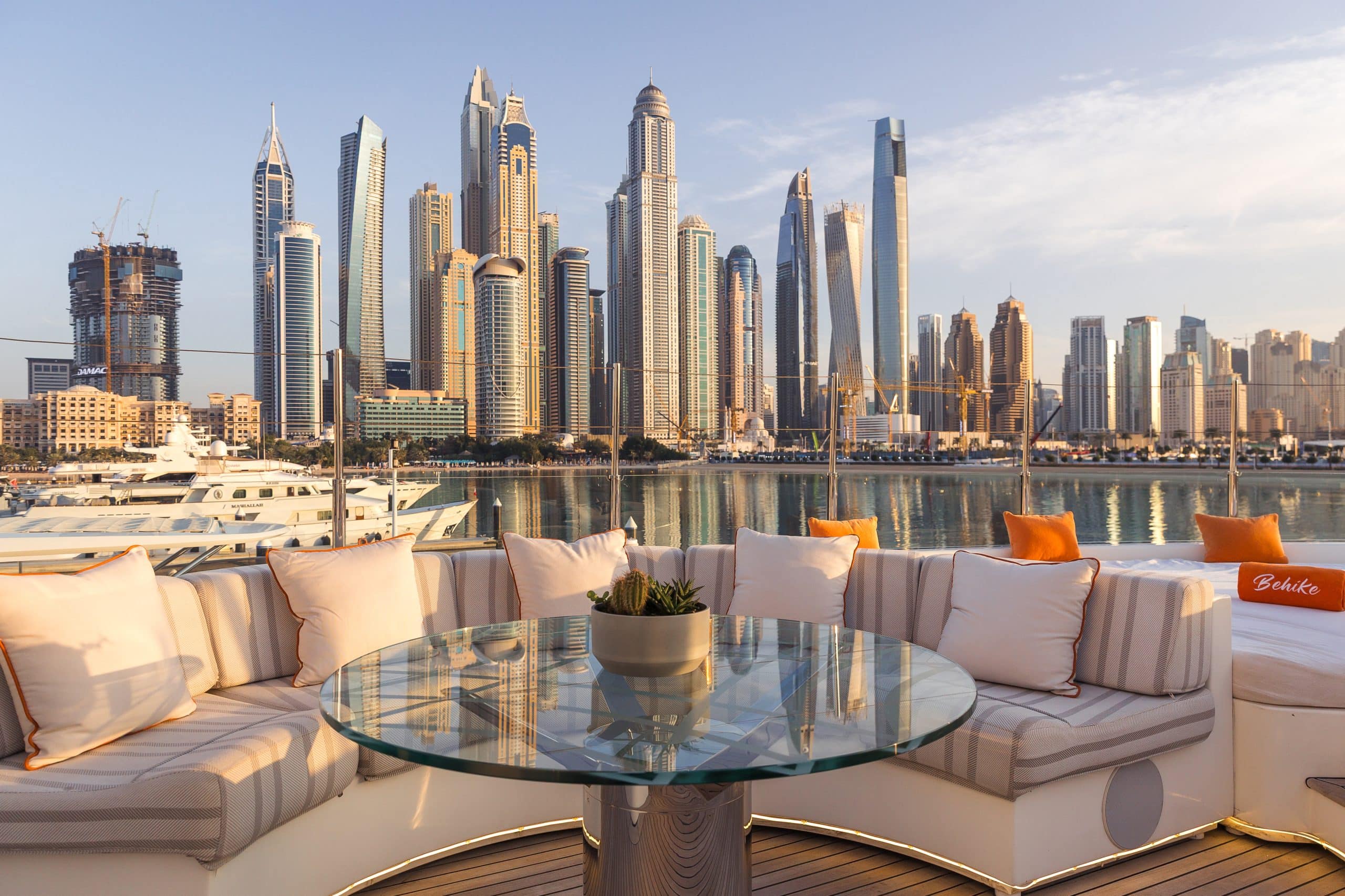Outdoor dining table on MILA 141 yacht overlooking Abu Dhabi skyline