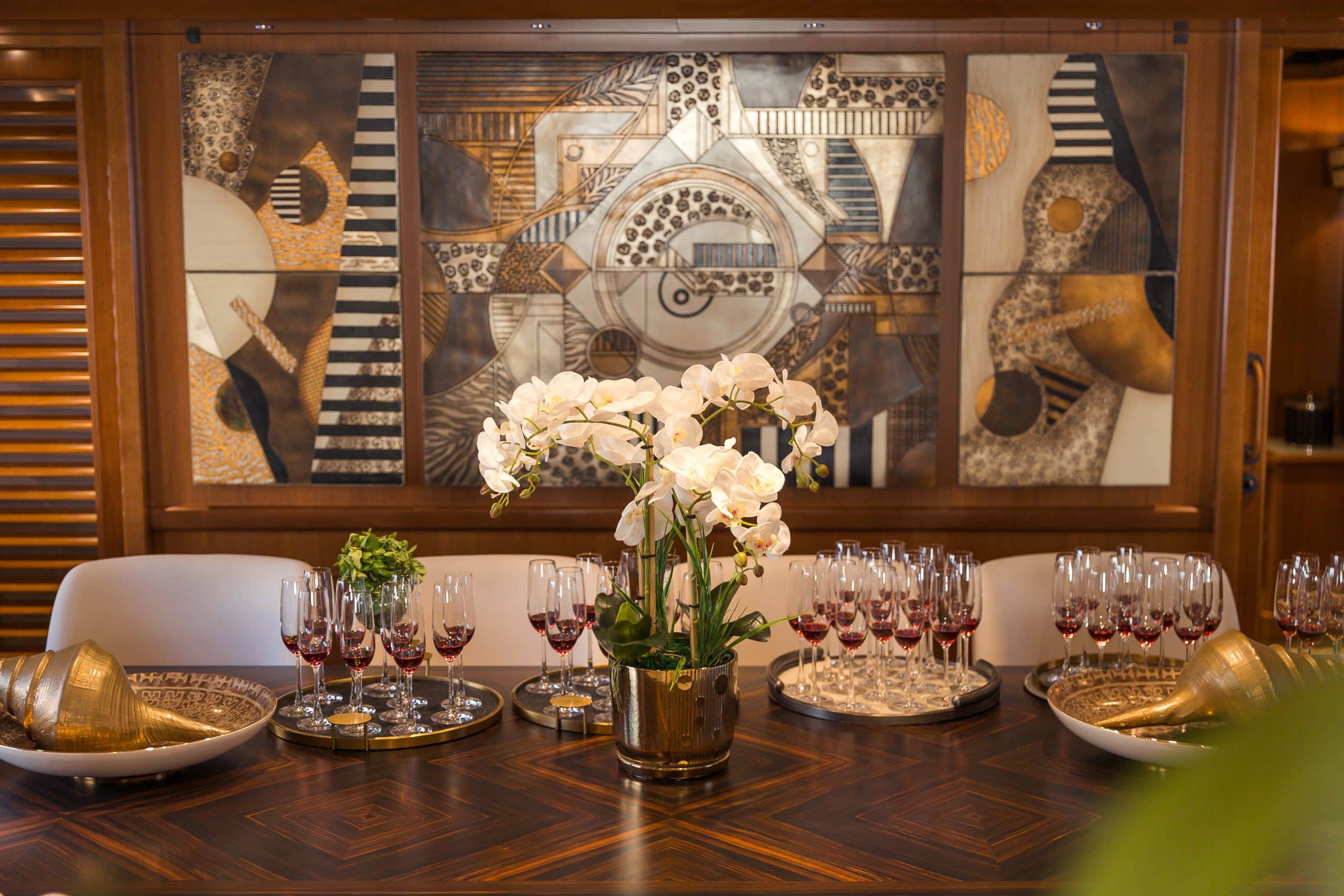 Elegant formal dining area onboard MILA 141 yacht with luxury table setting