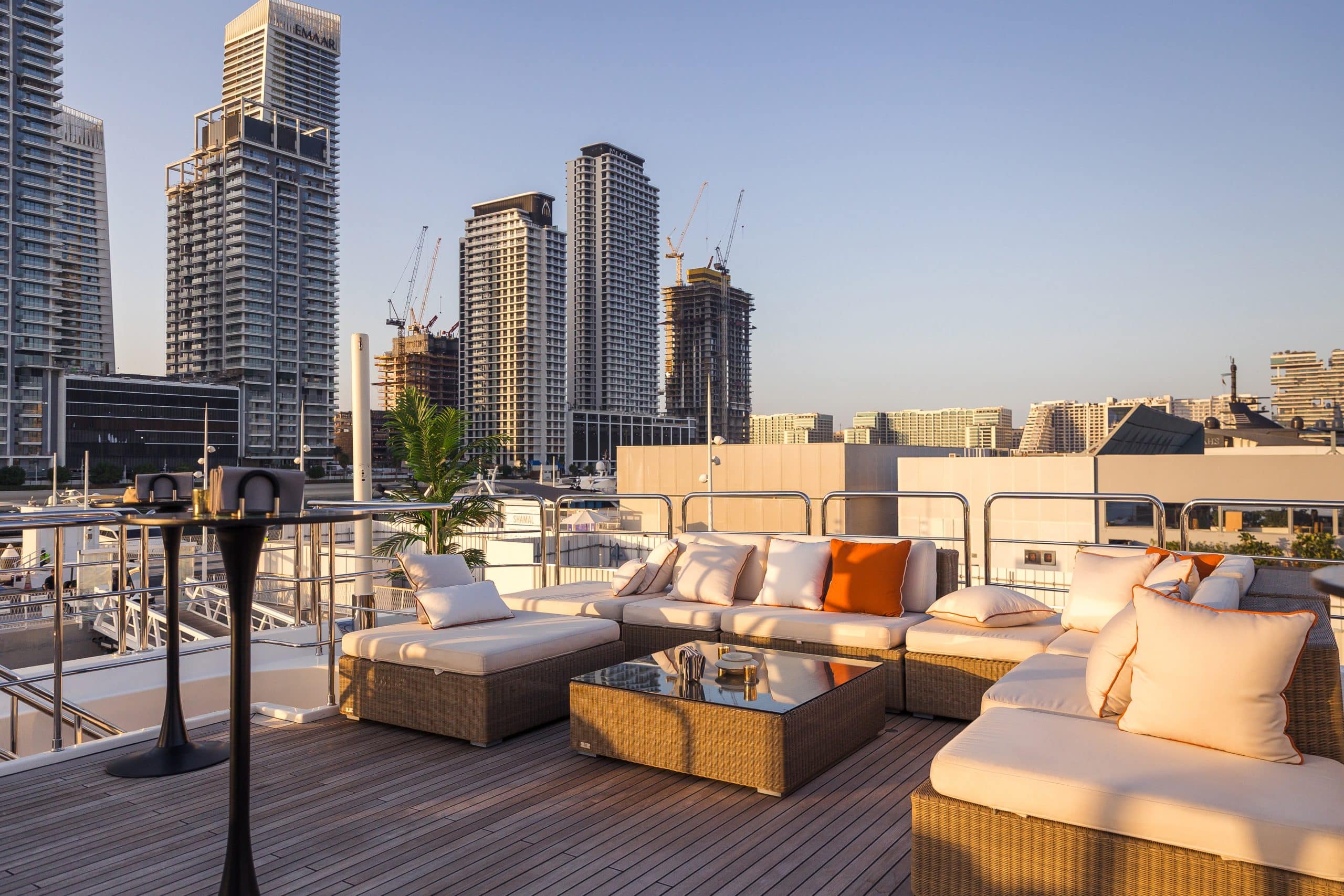 Luxury sun deck lounge on MILA 141 yacht overlooking Abu Dhabi skyline