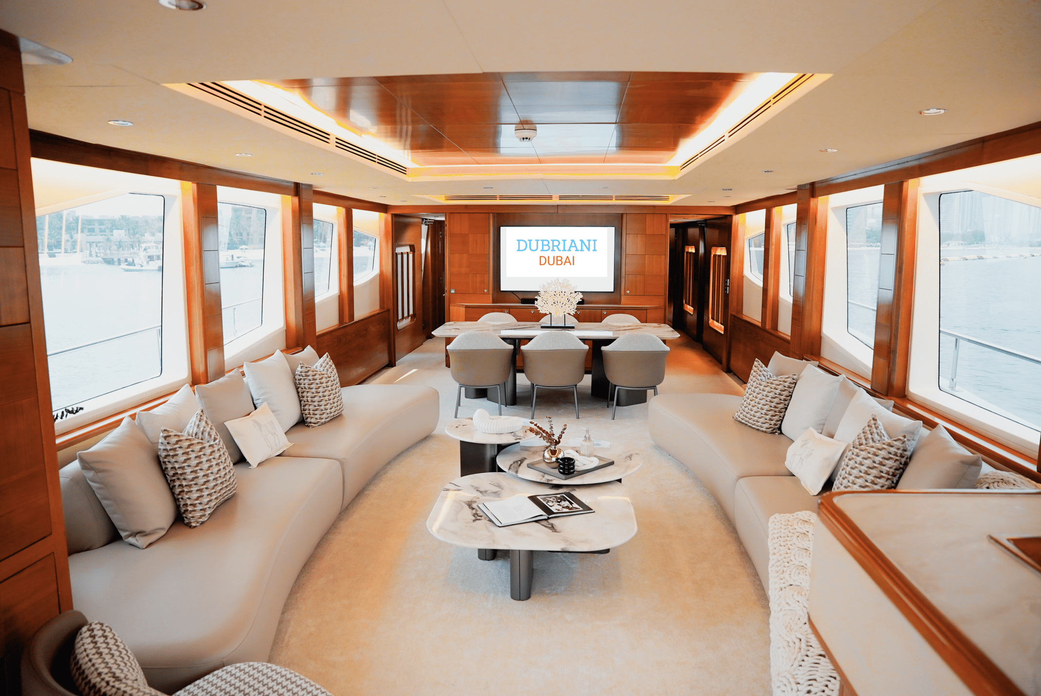 Spacious main salon lounge on Luna 101 yacht with panoramic windows at Yas Marina