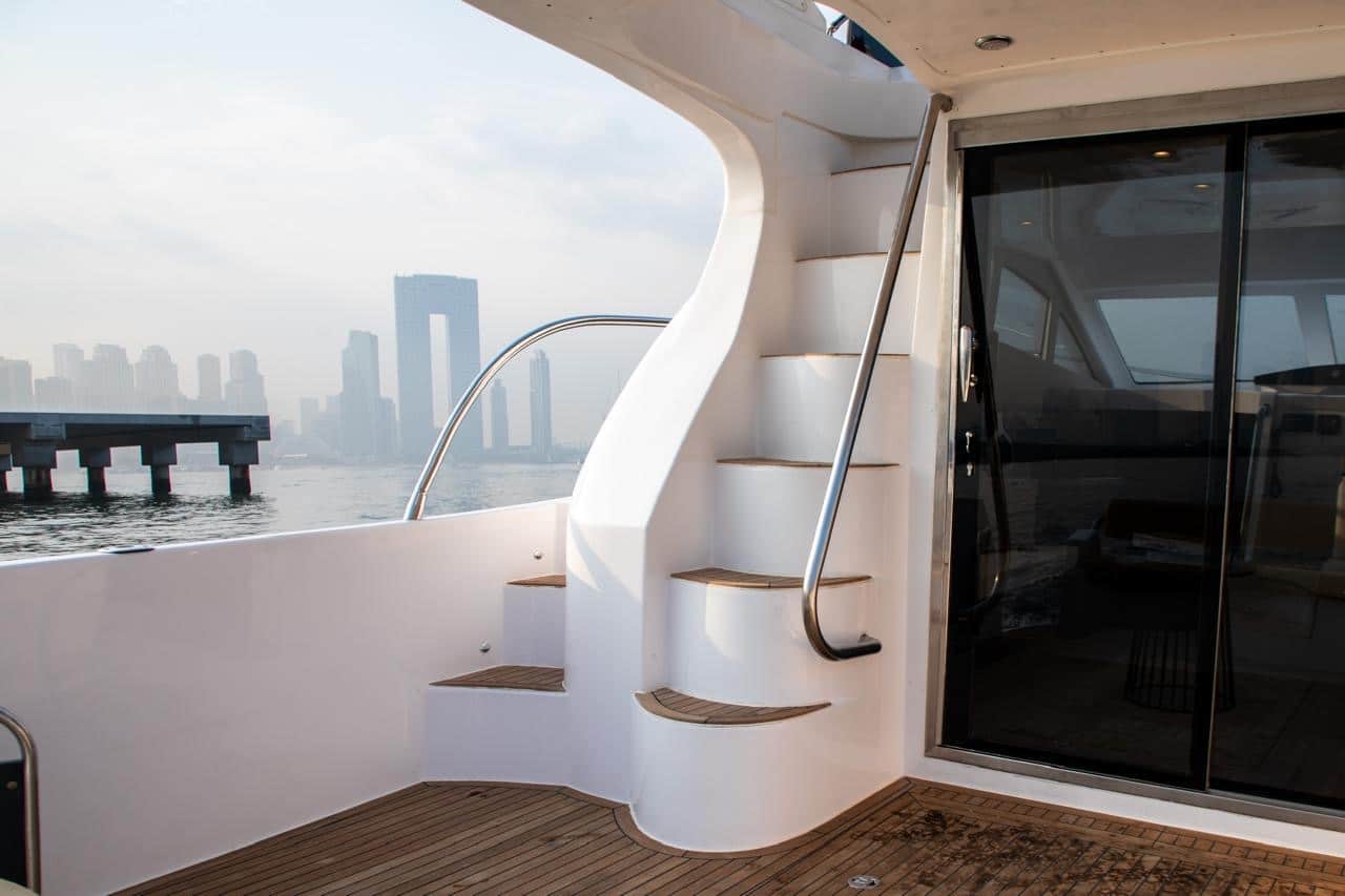 Elan 44 aft deck staircase and cabin entrance with Abu Dhabi skyline view
