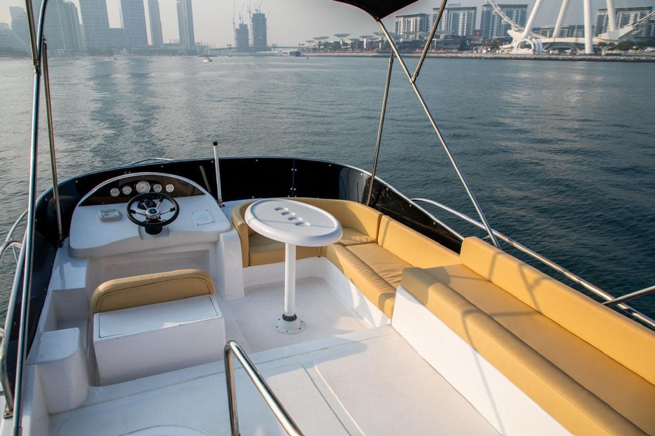 Elan 44 cockpit lounge seating with marina and skyline background