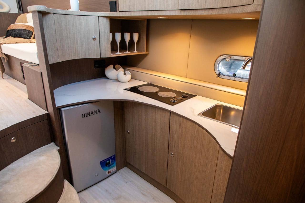 Elan 44 galley kitchen with sink, storage cabinets and fridge