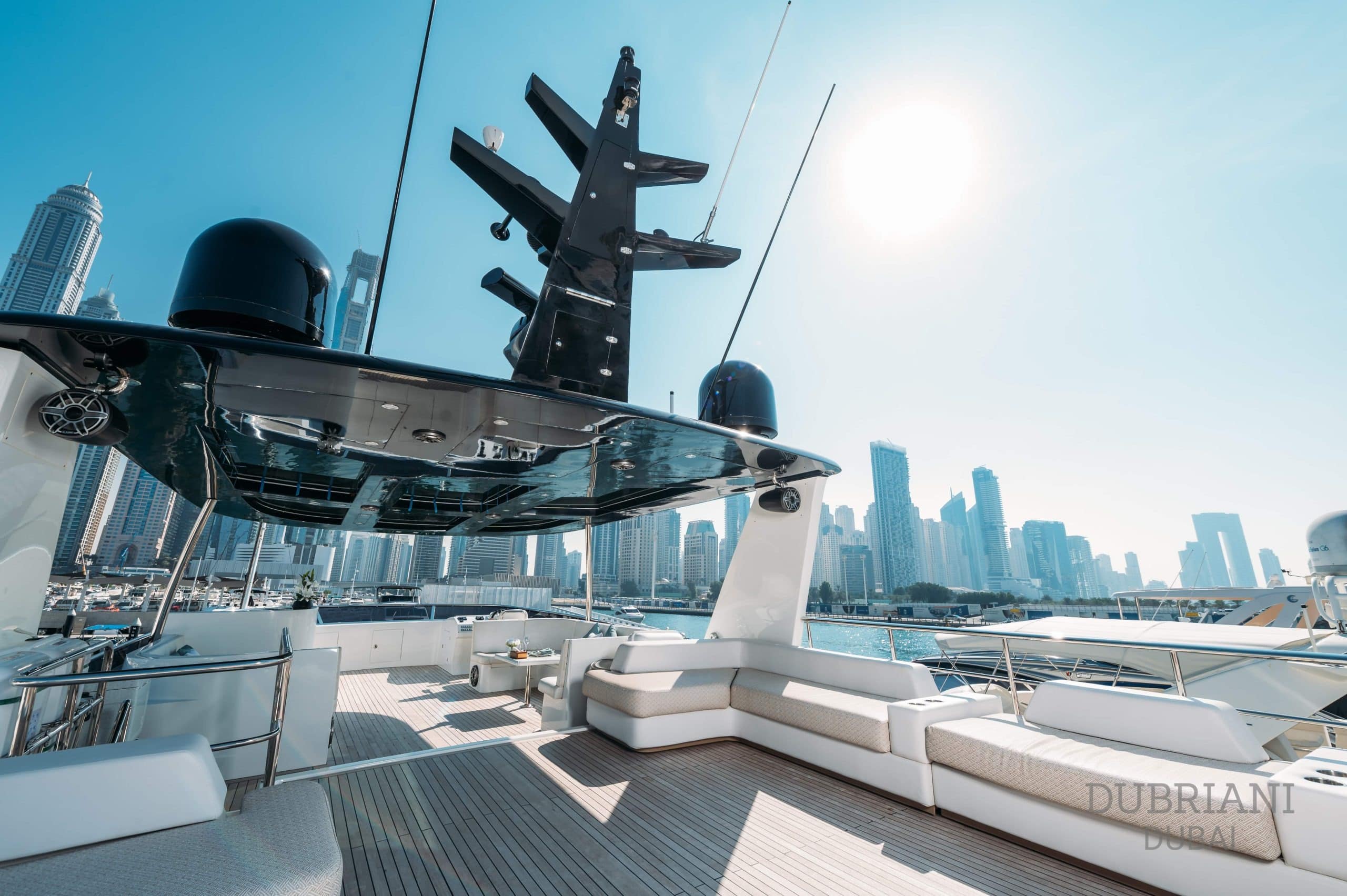 Eclipse yacht sun deck with lounge seating and city skyline in background