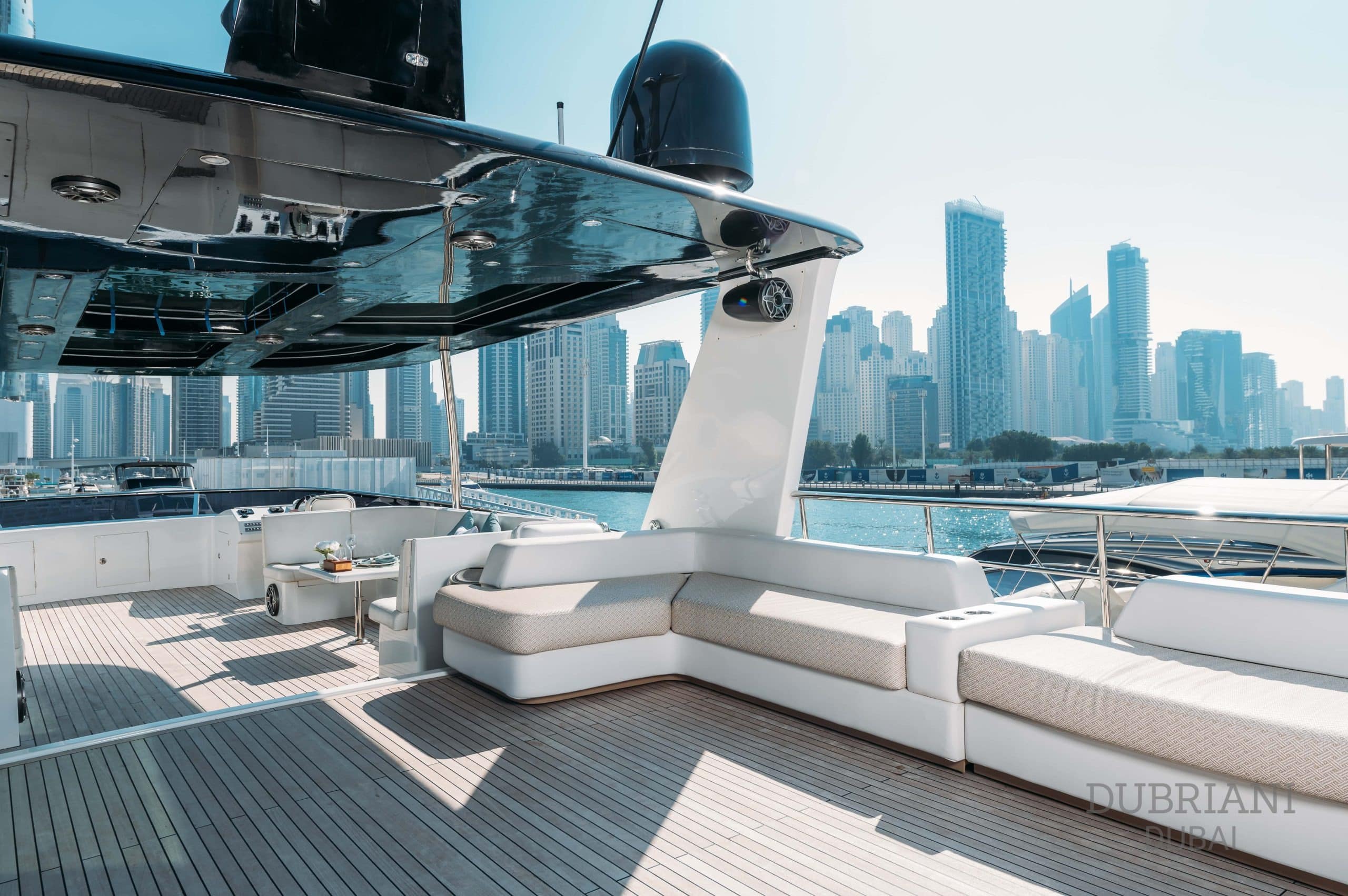 Luxury outdoor lounge and dining space on Eclipse yacht with panoramic city views