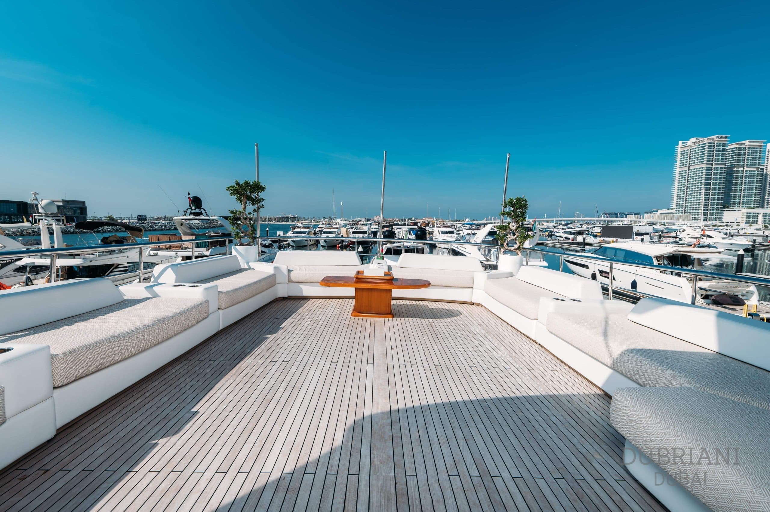 Teak wood deck walkway on Eclipse superyacht with sun loungers and open sea view