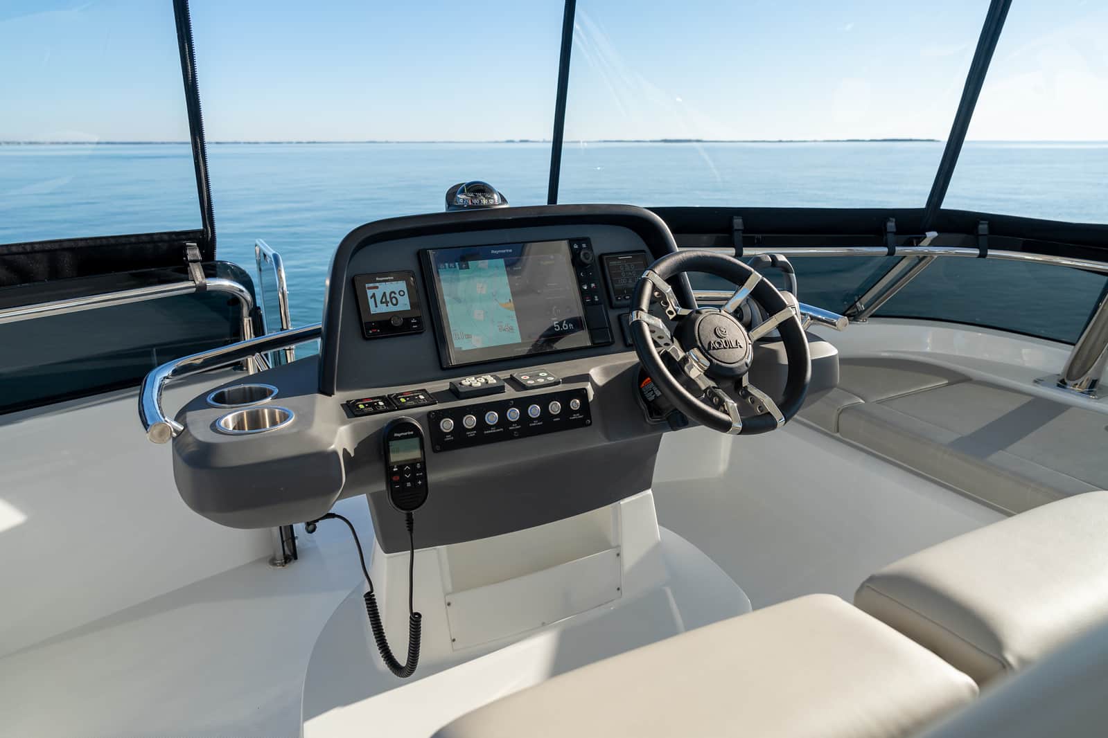 Aquila 42 flybridge helm console with navigation screens, shipyard photo