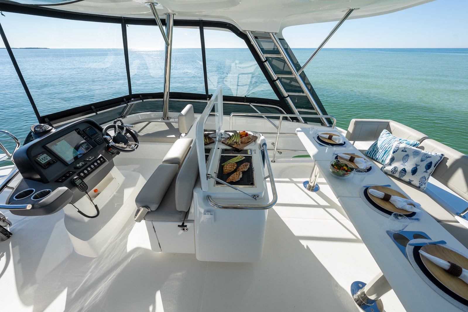 Aquila 42 flybridge helm and dinette under hardtop, shipyard photo