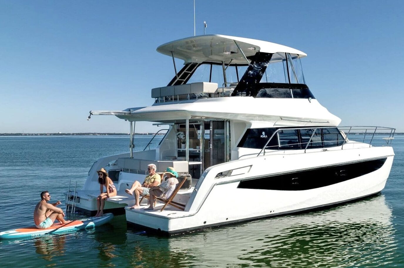 Aquila 42 at anchor with paddleboard alongside, shipyard photo