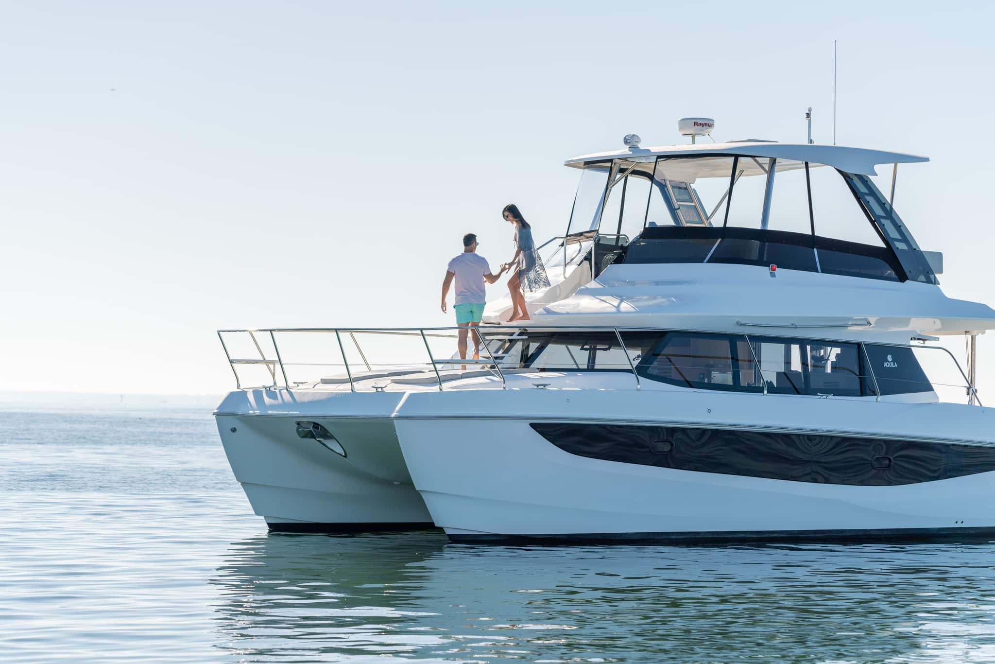 Aquila 42 power catamaran port profile at anchor, shipyard photo