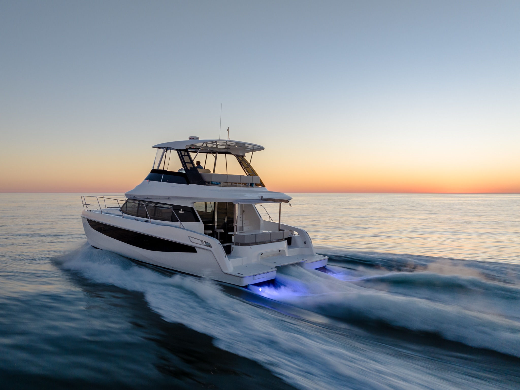 Aquila 42 running at sunset with underwater lights, shipyard photo
