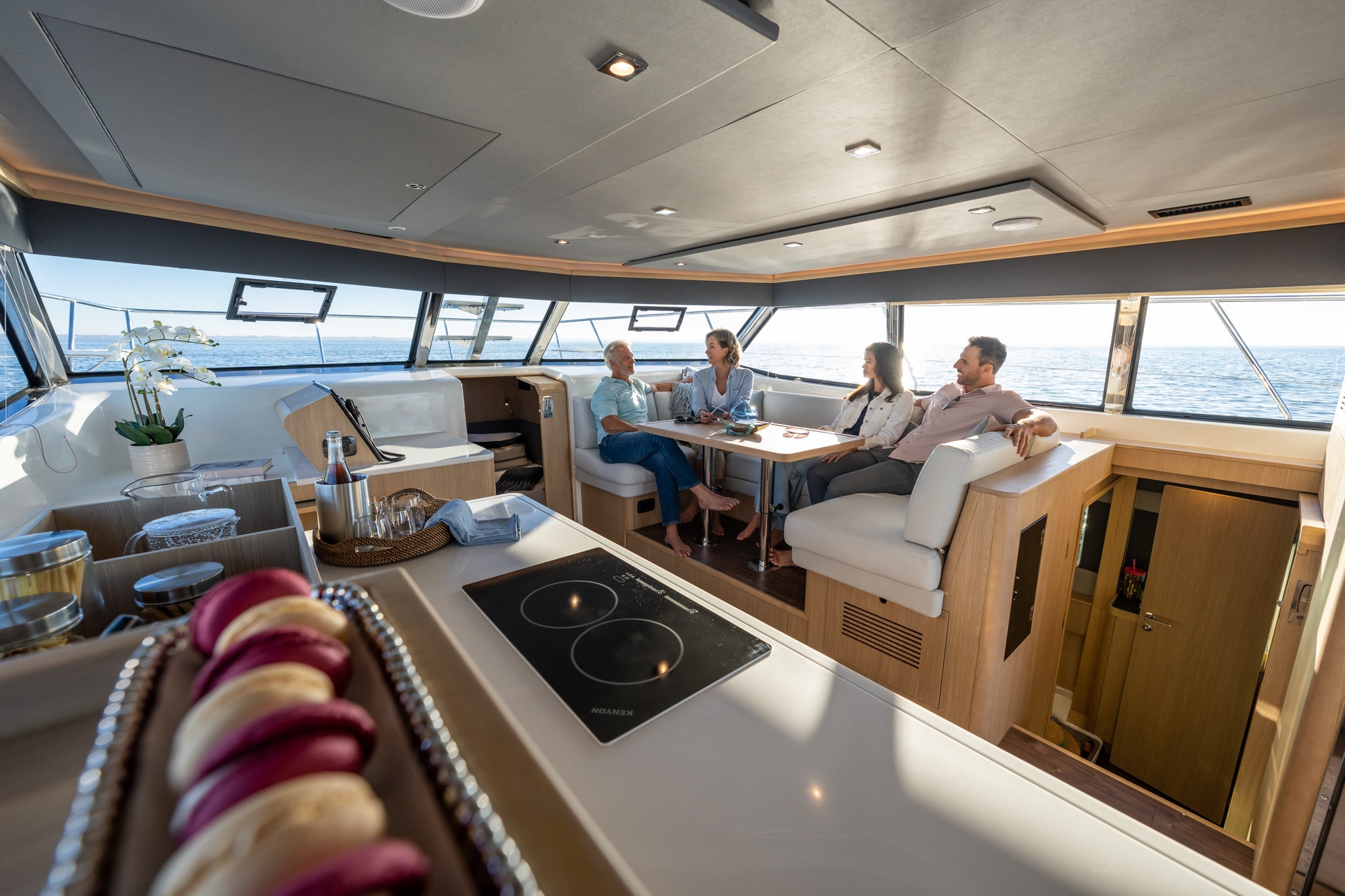 Aquila 42 saloon dining with guests at the table, shipyard photo