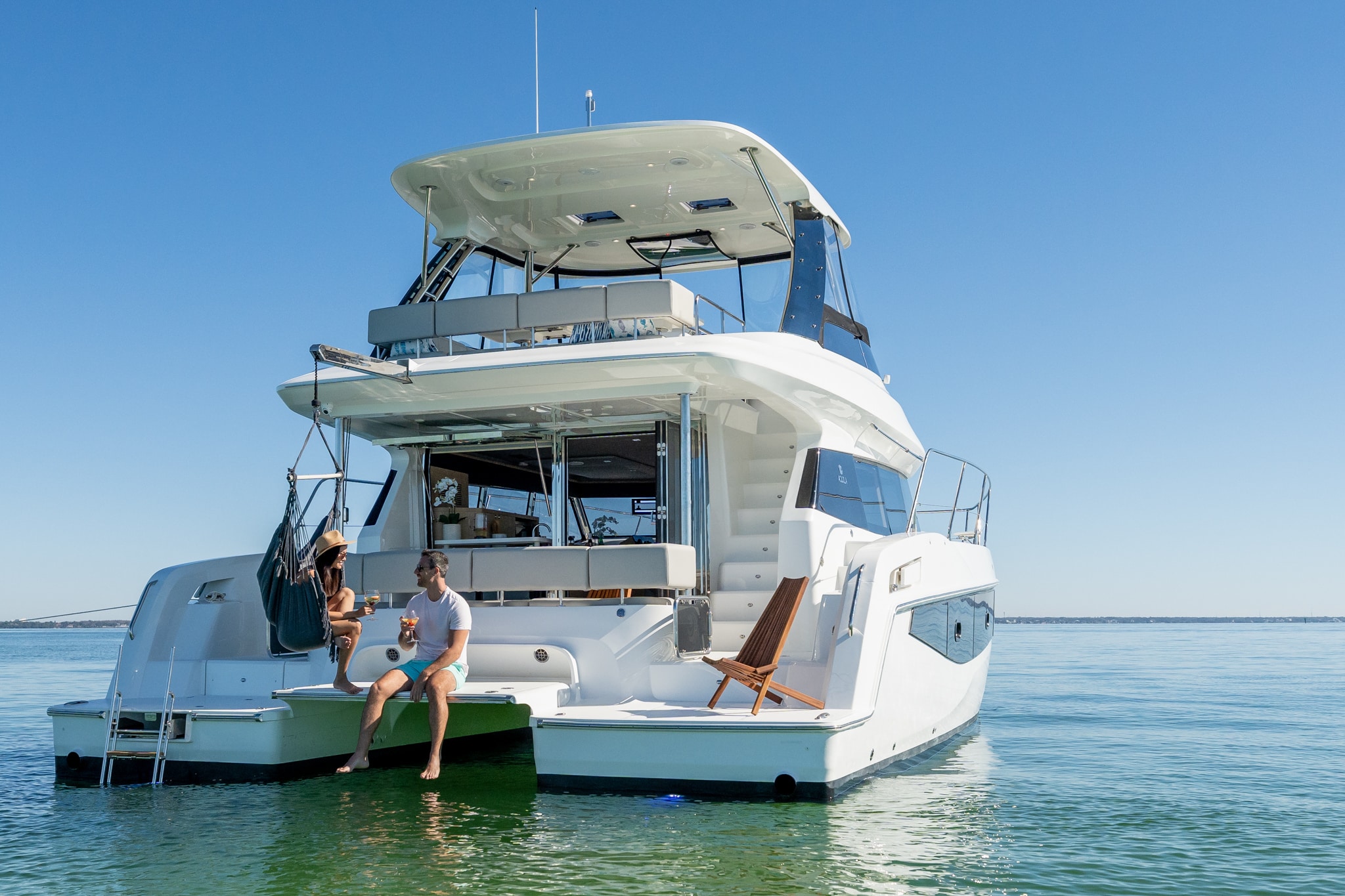 Aquila 42 stern view at anchor with swim platform, shipyard photo