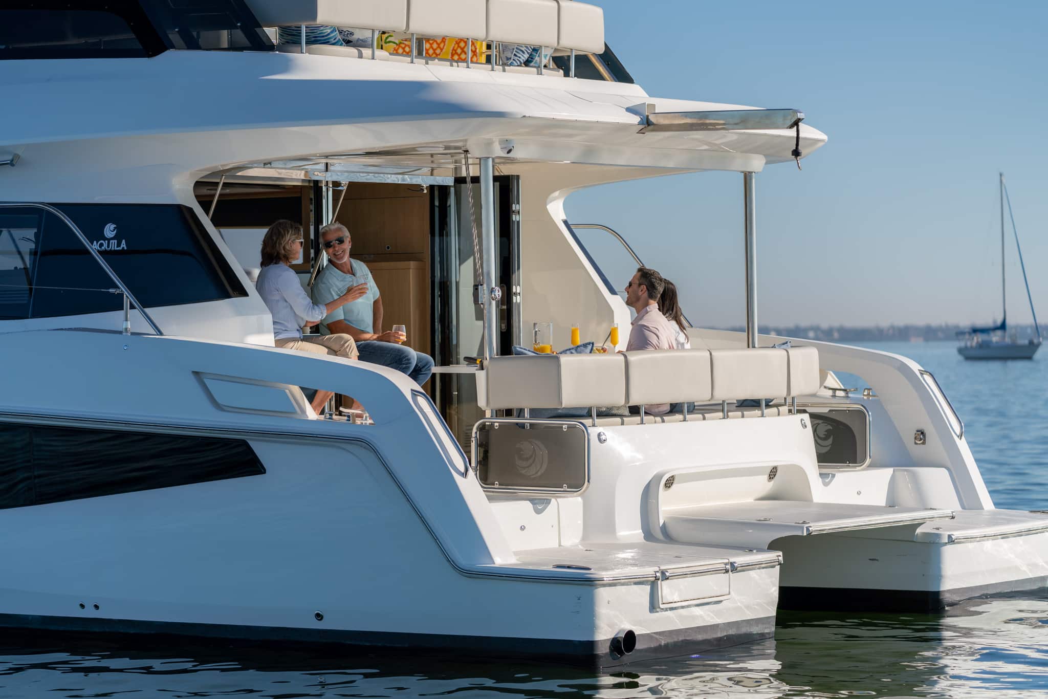 Aquila 42 stern quarter with guests boarding, shipyard photo
