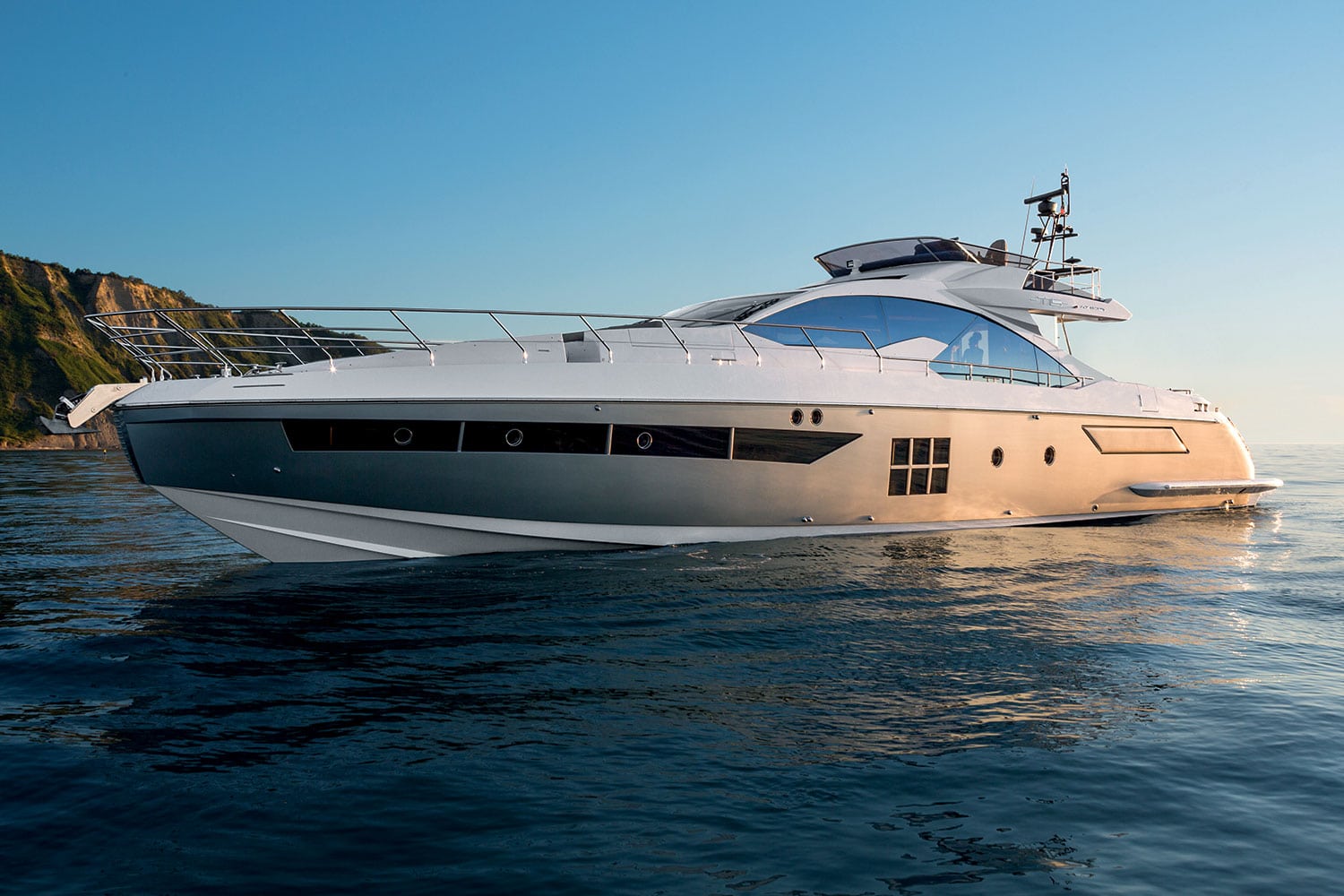 Azimut 77S broadside profile at anchor at golden hour — shipyard photo