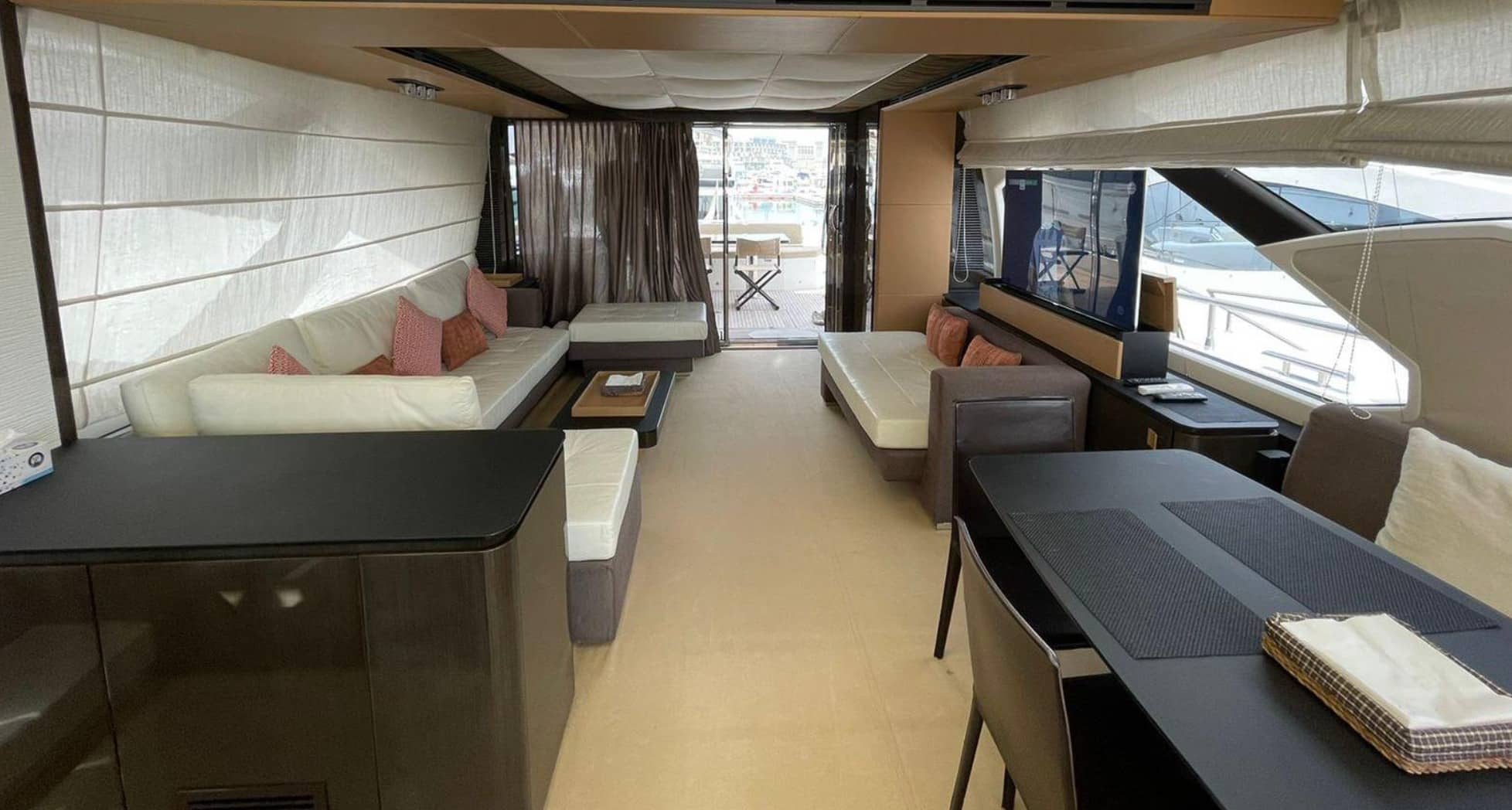 Azimut 77S main saloon looking aft with cream leather sofas