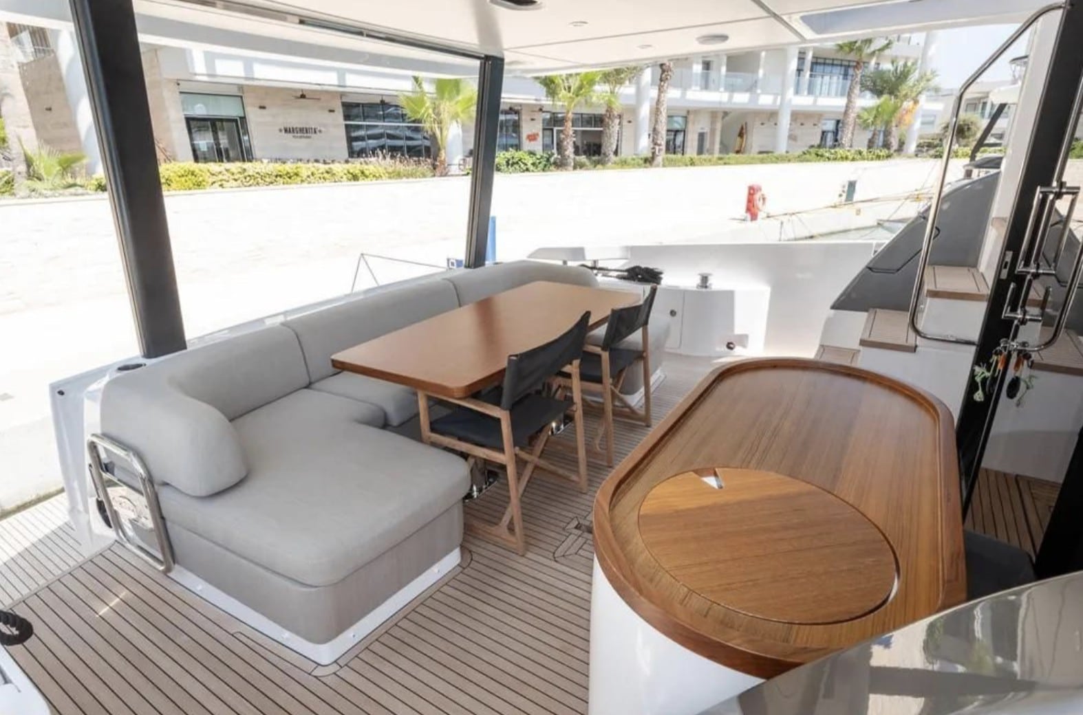 Azimut Fly 68 aft deck dining beside the marina — press photo