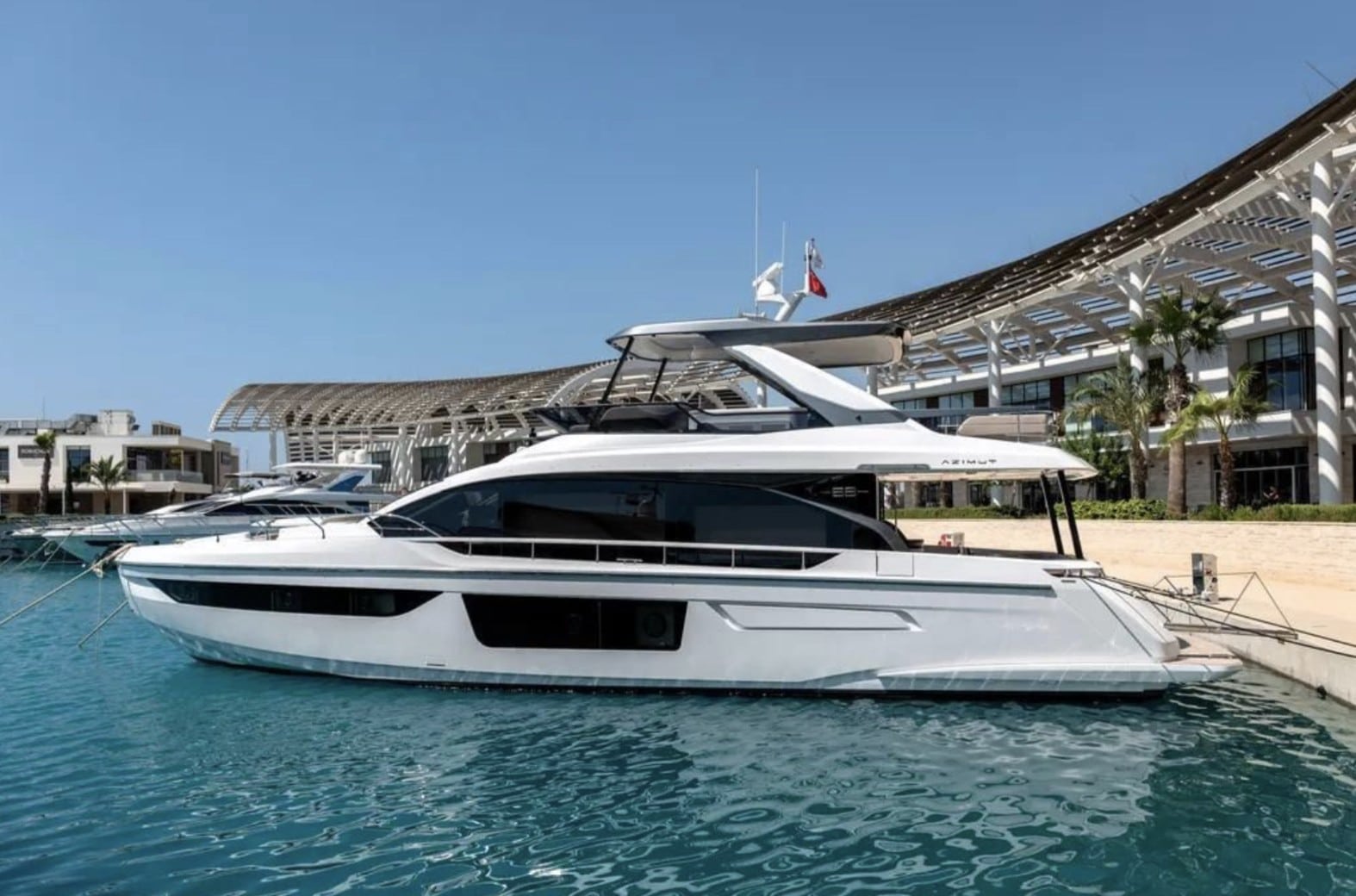 Azimut Fly 68 white-hull profile at the marina — press photo