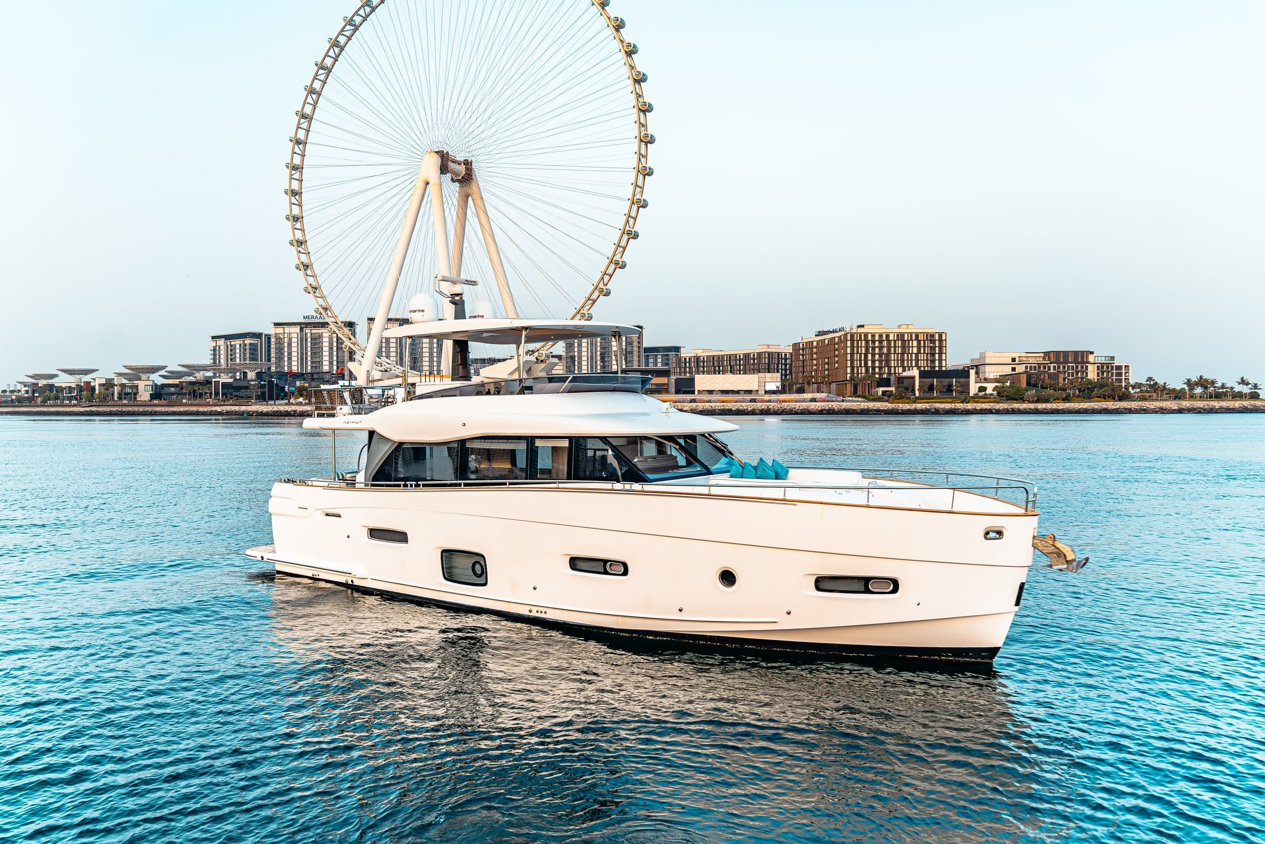 Azimut Magellano 66 profile cruising off Dubai with Ain Dubai behind