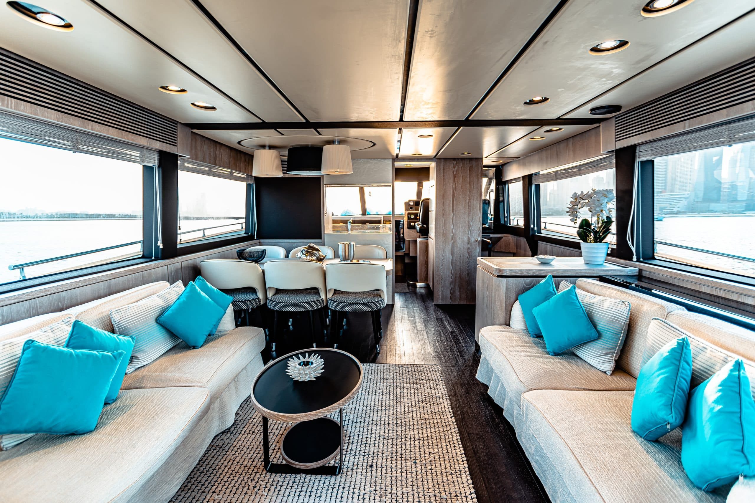 Azimut Magellano 66 main saloon with white sofas, turquoise accents