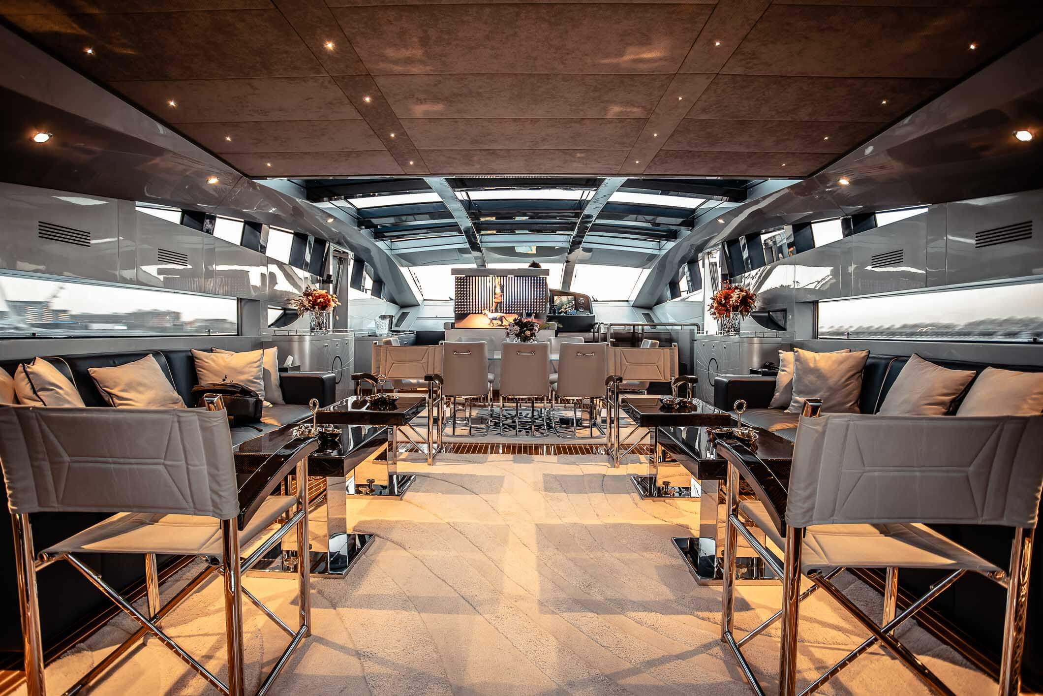 Baglietto 105 HT main saloon with bar and warm oak finish