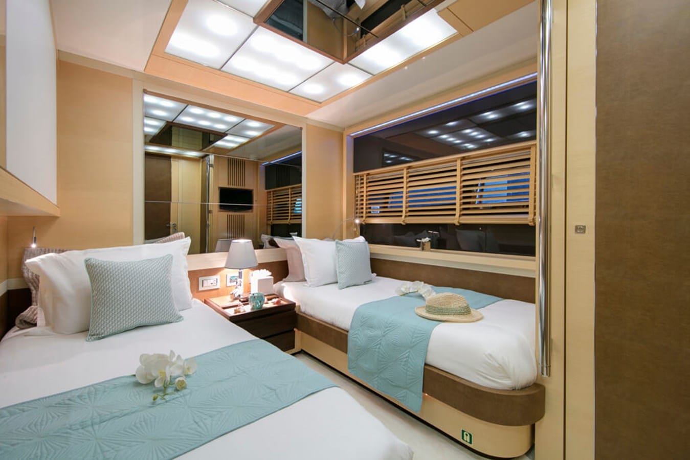 Baia 100 twin guest cabin with two berths and aqua throws