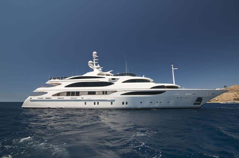 Benetti 56M aerial bow view cutting through calm open water