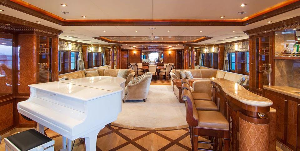 Benetti 56M main saloon with white grand piano and cocktail bar