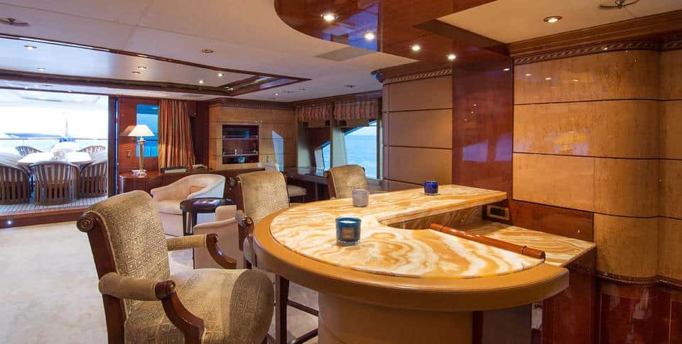 Benetti 56M sky lounge with card table opening onto the aft deck