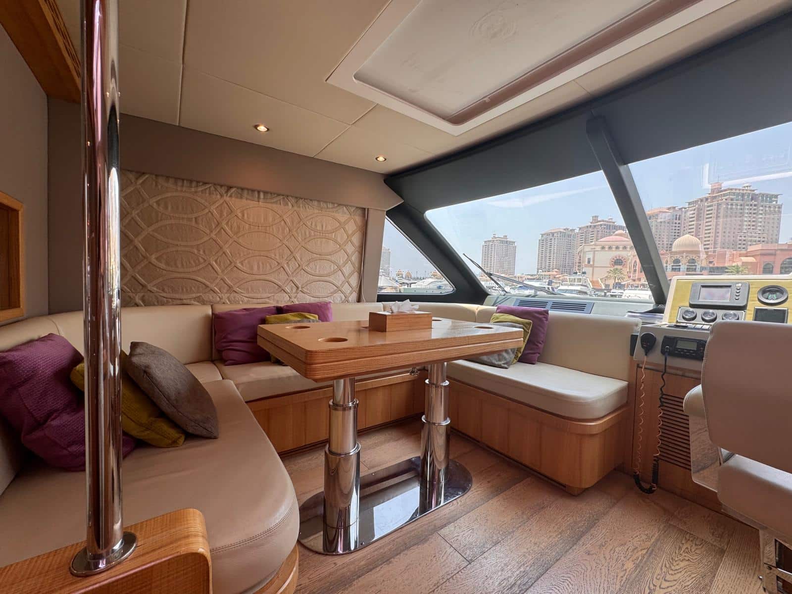 Nomad 65 dinette beside the lower helm with marina views
