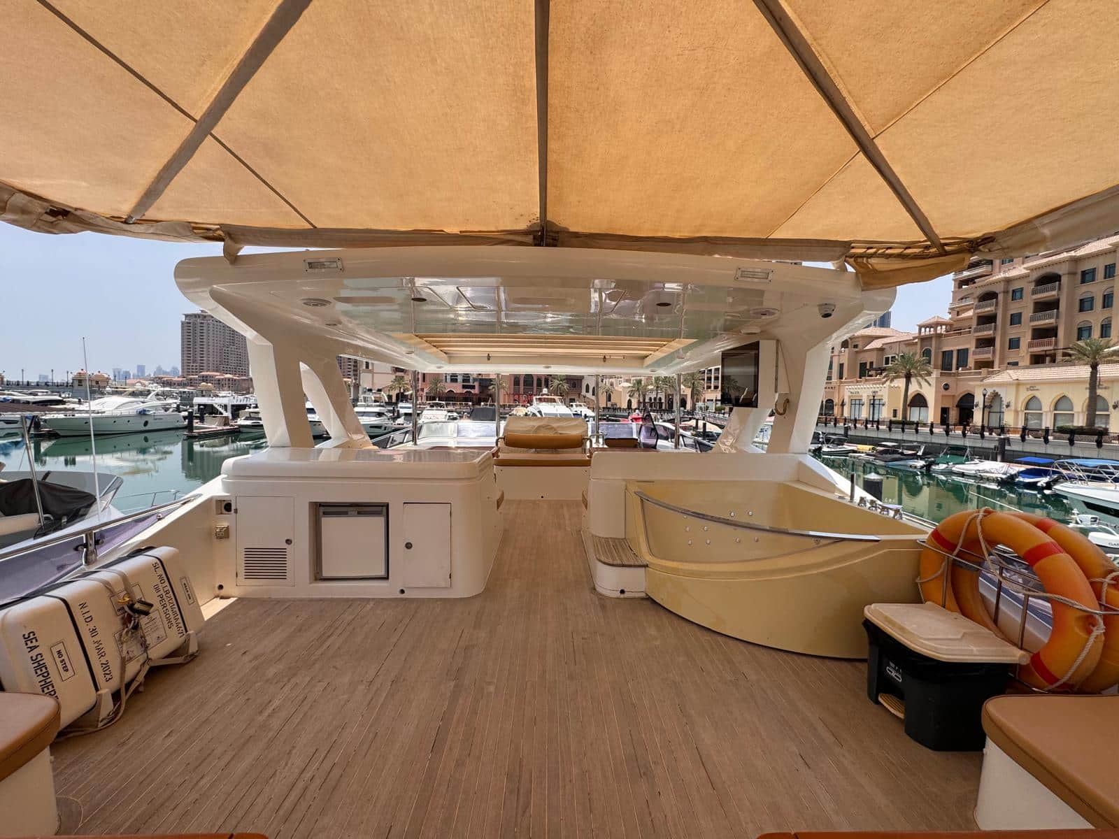 Nomad 65 flybridge deck with bar, seating and bimini shade