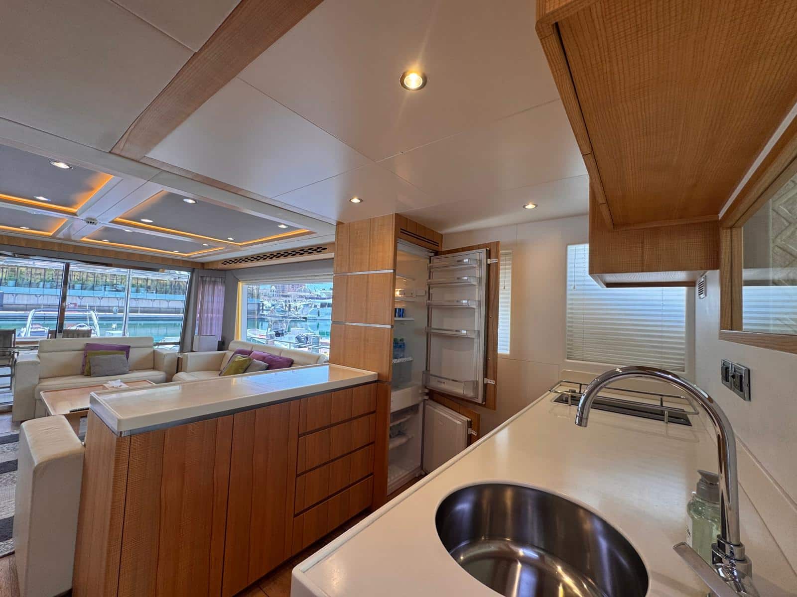 Nomad 65 galley with full-height fridge open to the saloon