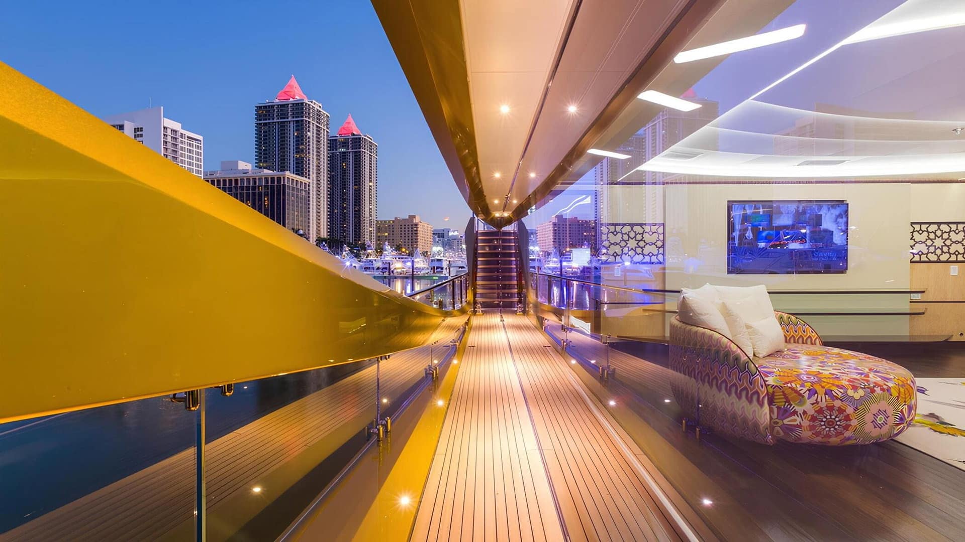 SuperSport 48 side deck at dusk with the city skyline astern