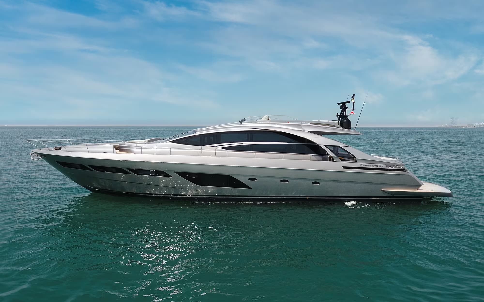 Pershing 8X silver-hulled profile on calm water, flybridge and mast