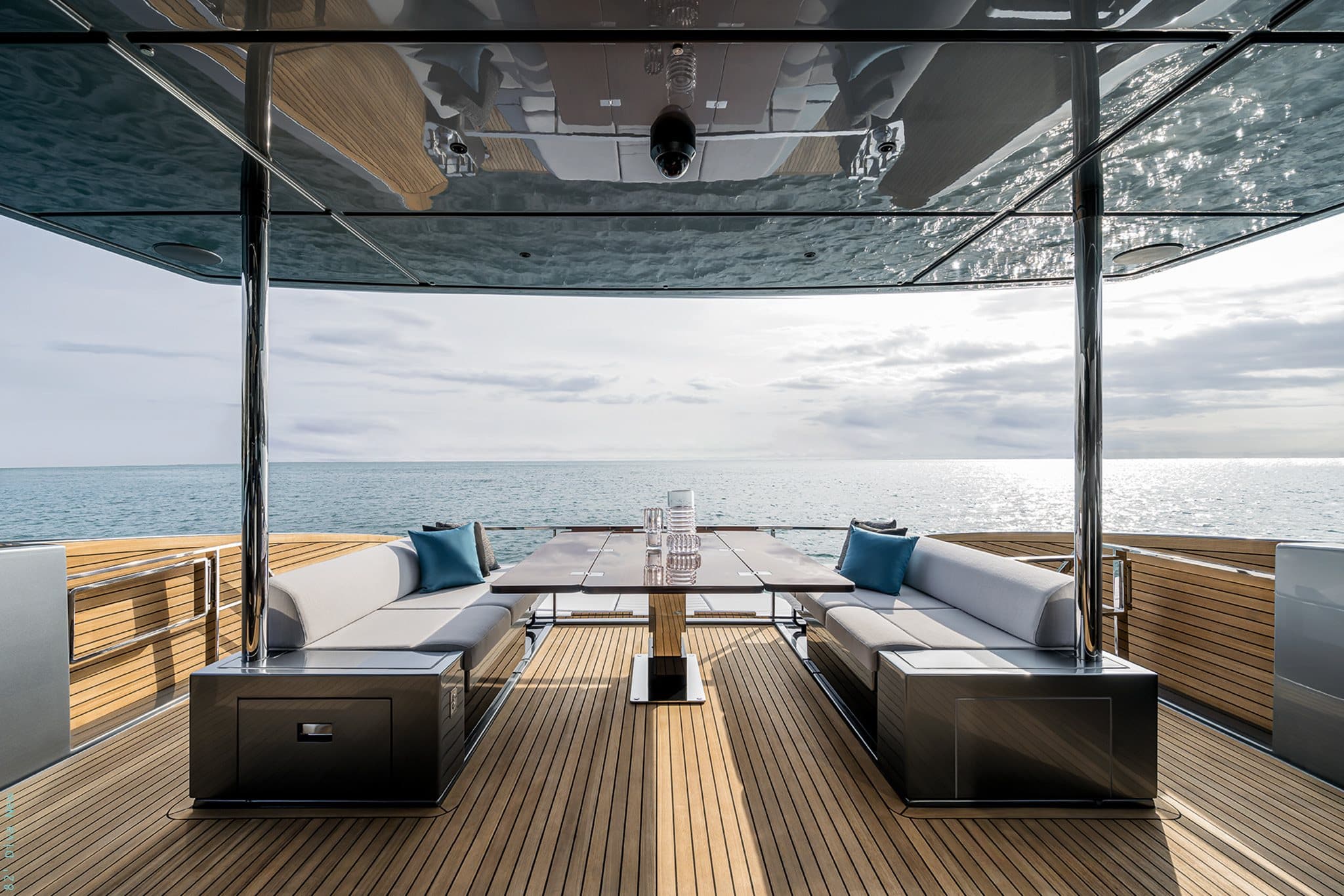 Riva 82 Diva flybridge dining table between twin sofas, sea view