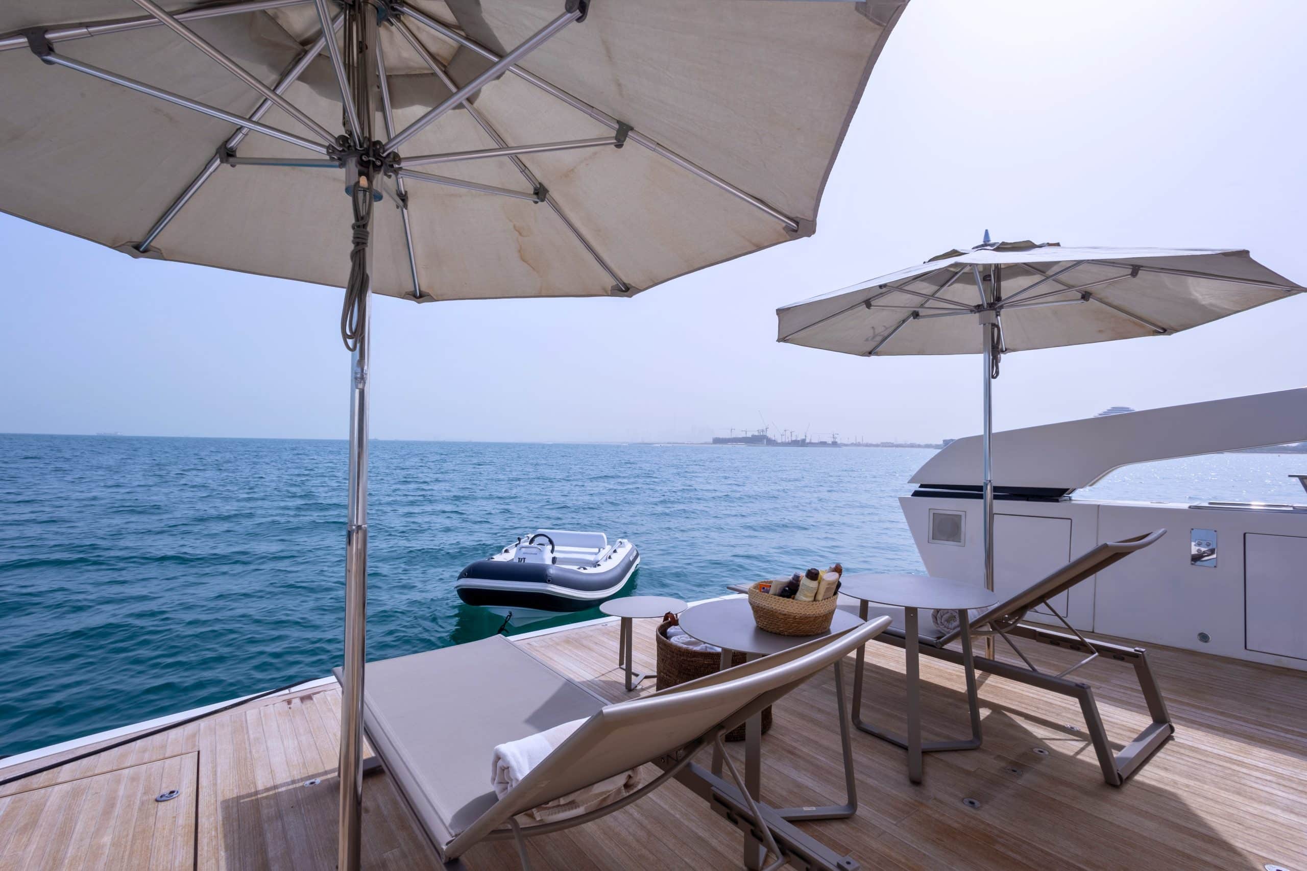 SanLorenzo SX88 beach club sun loungers under umbrellas at anchor