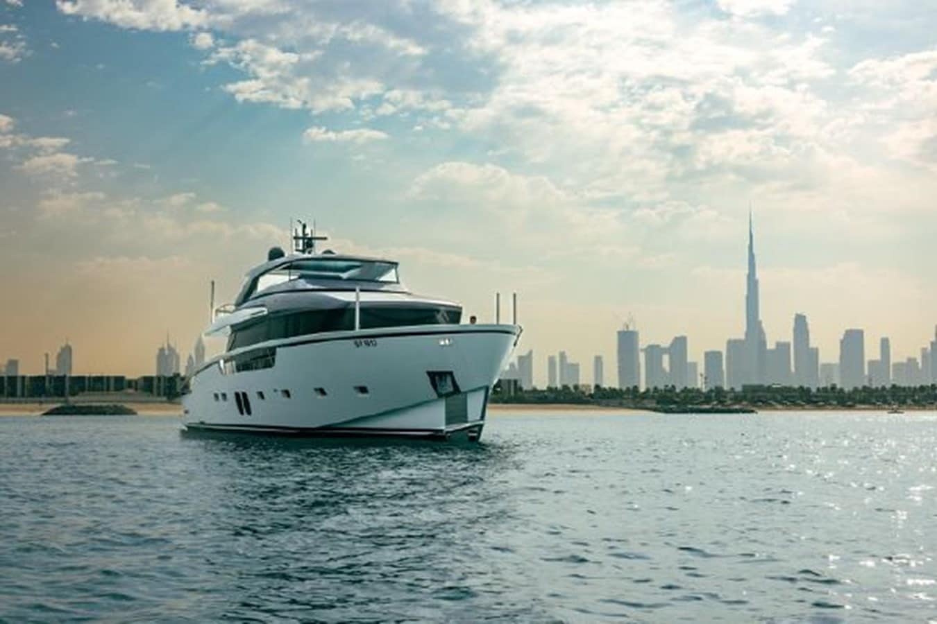 SanLorenzo SX88 bow quarter view with the Dubai skyline, broker photo