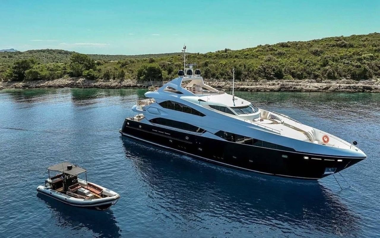 Sunseeker 37M bow-quarter aerial at anchor with chase tender alongside