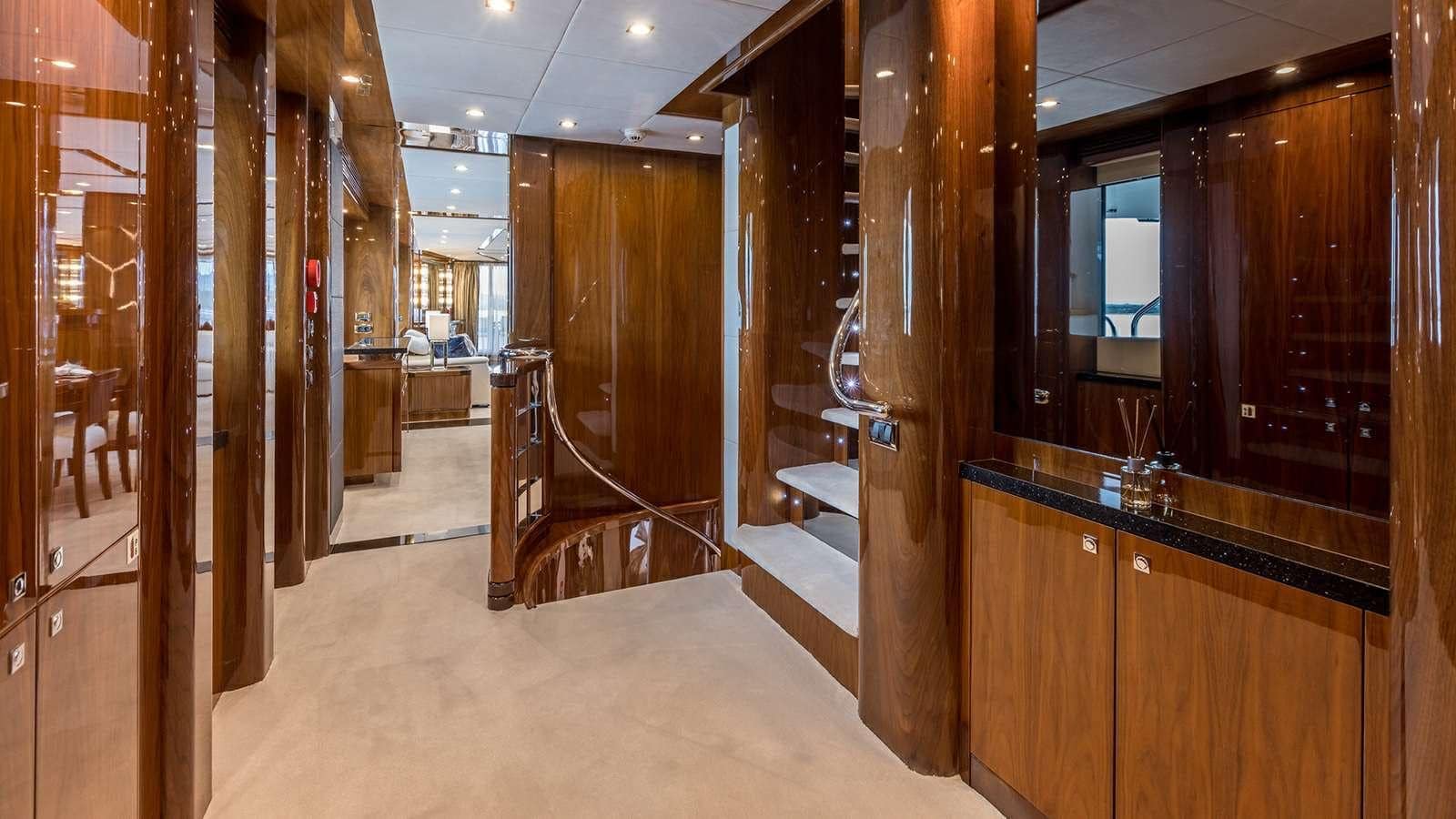Sunseeker 37M guest lobby with curved staircase, gloss walnut