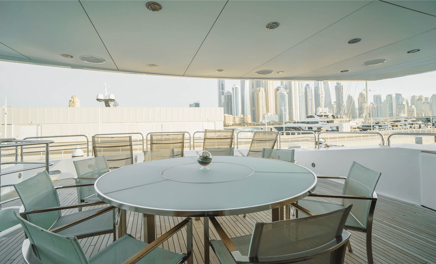 Sunseeker 40M covered aft deck with round al fresco dining table