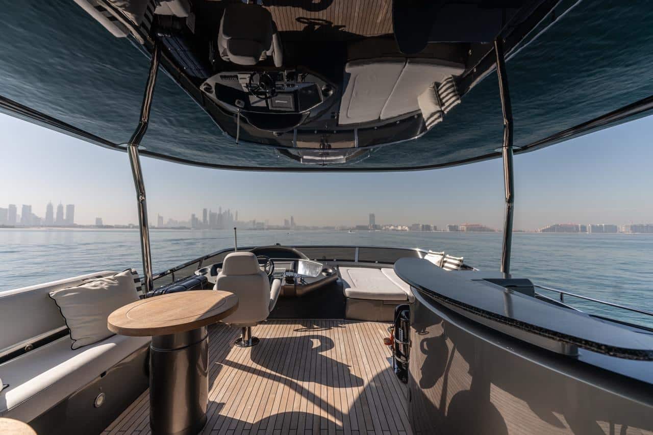 Sunseeker 82 Yacht flybridge helm and sunpad lounge under canopy
