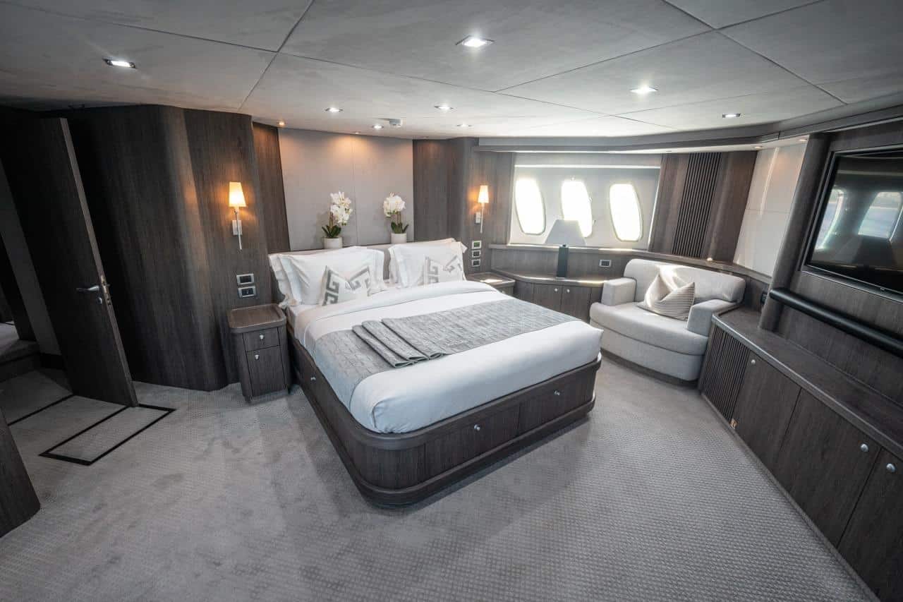 Sunseeker 82 Yacht master cabin with sofa and warm lighting
