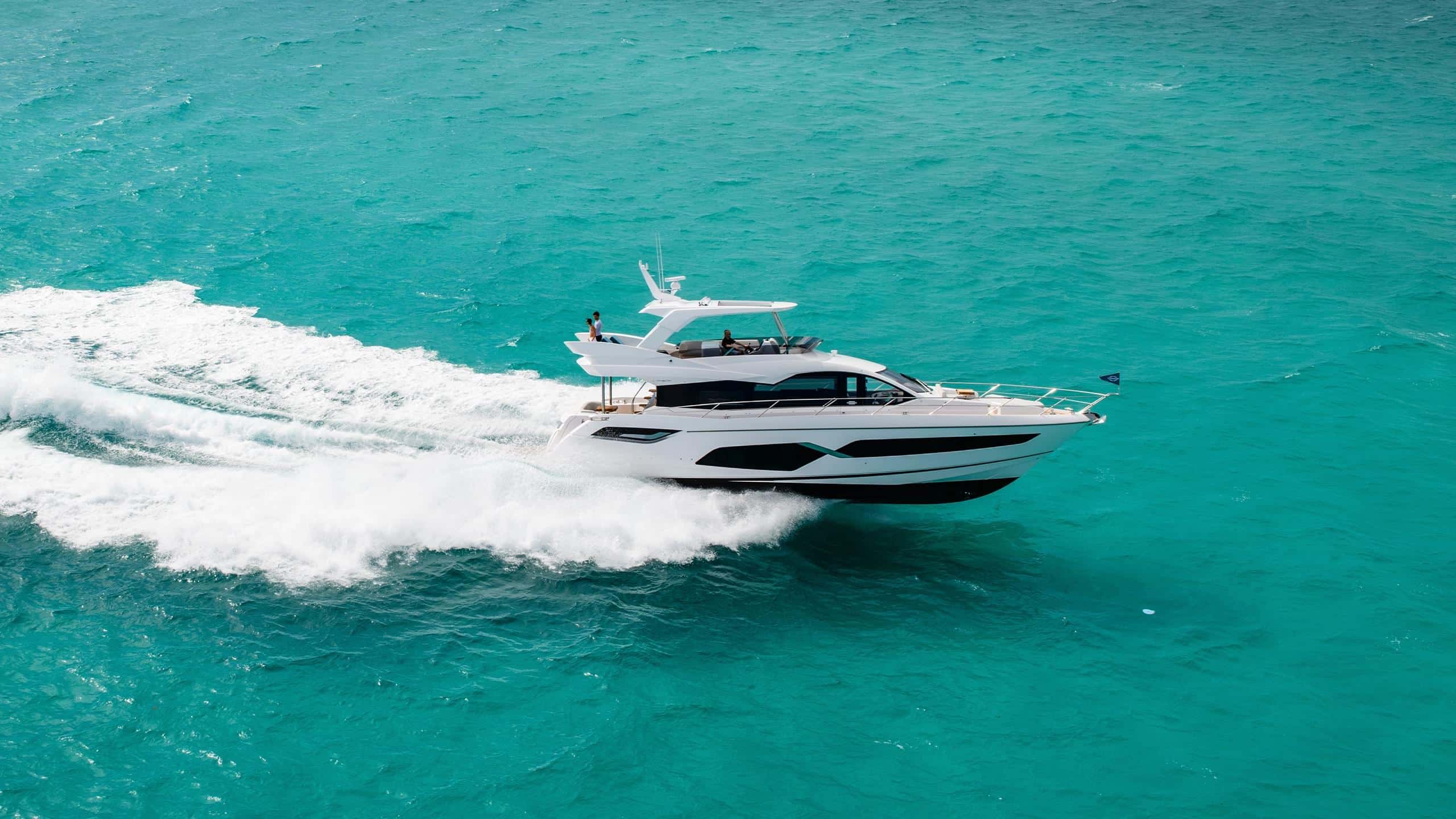 Sunseeker Manhattan 68 cruising clear turquoise water — shipyard photo