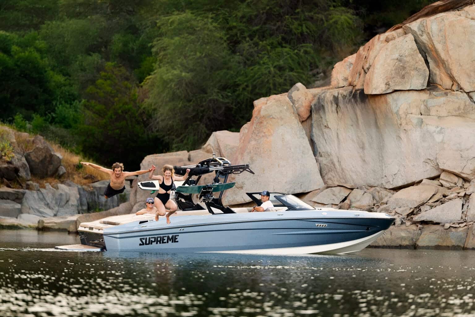 Supreme S240 bow view resting by a rocky cove — press photo