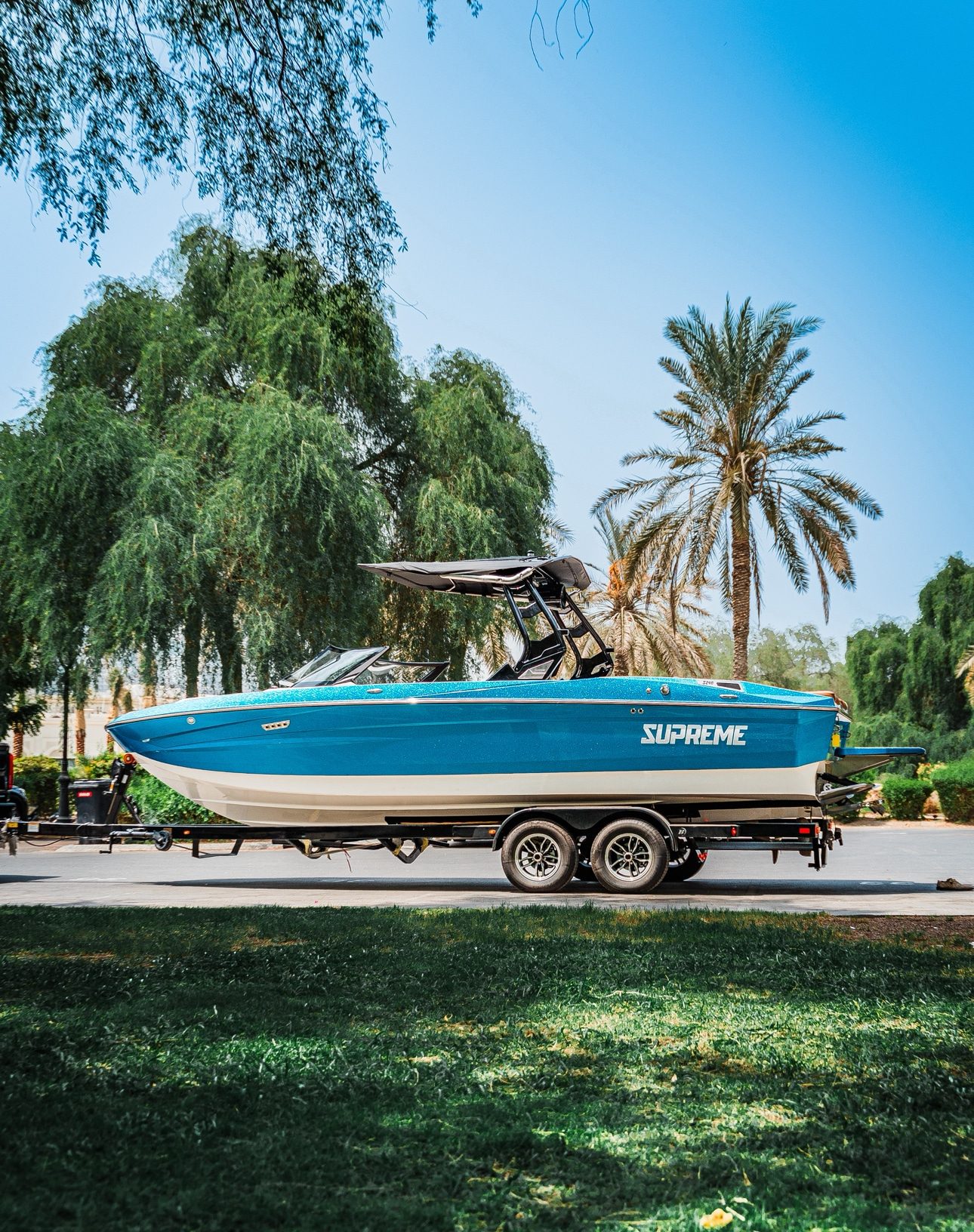 Supreme S240 full side profile on trailer, blue metallic hull