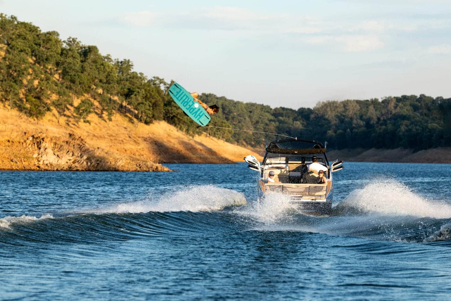 Supreme S240 stern view running with a wakeboarder — press photo